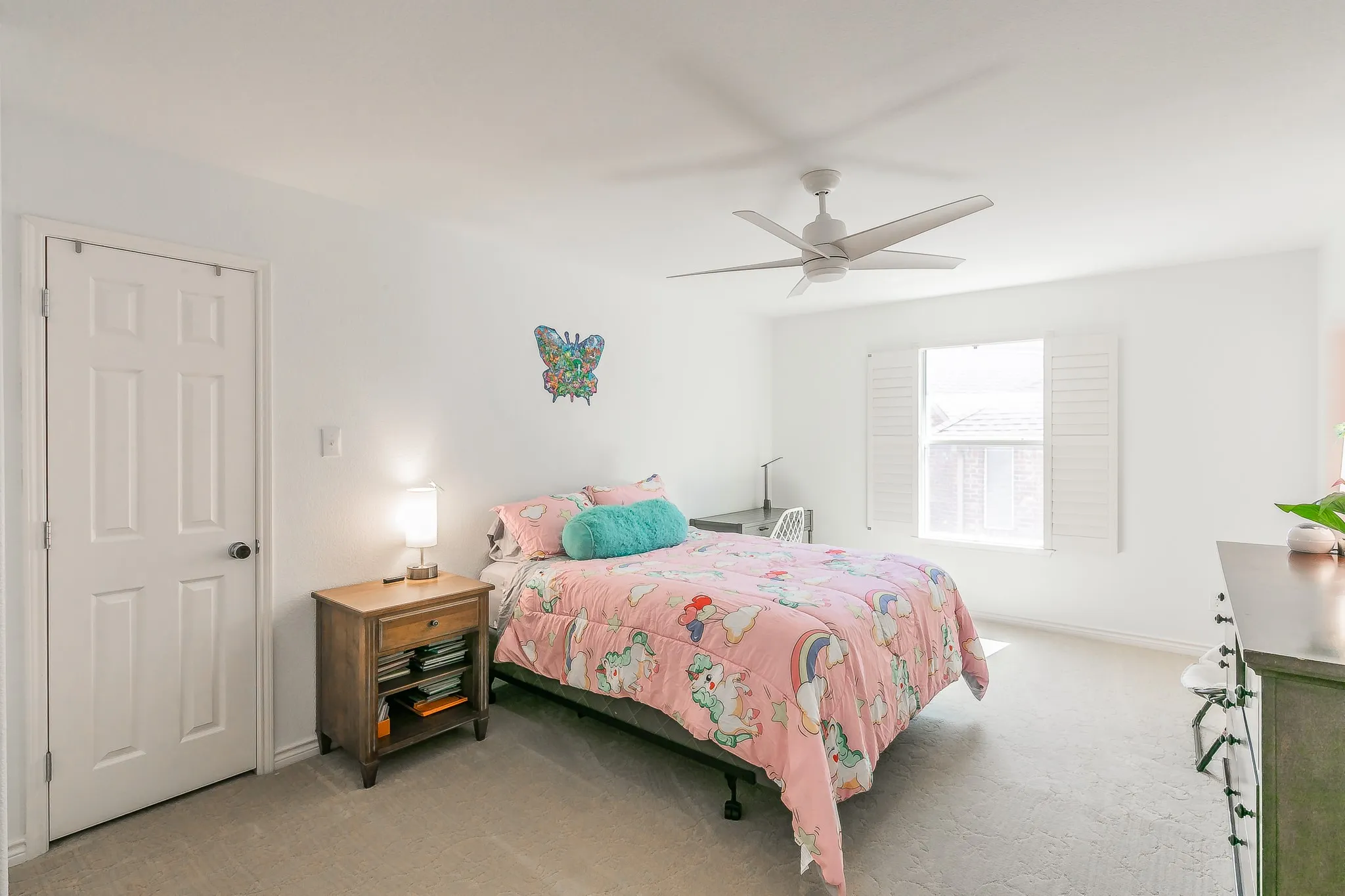 Bedroom with light carpet, baseboards, and ceiling fan