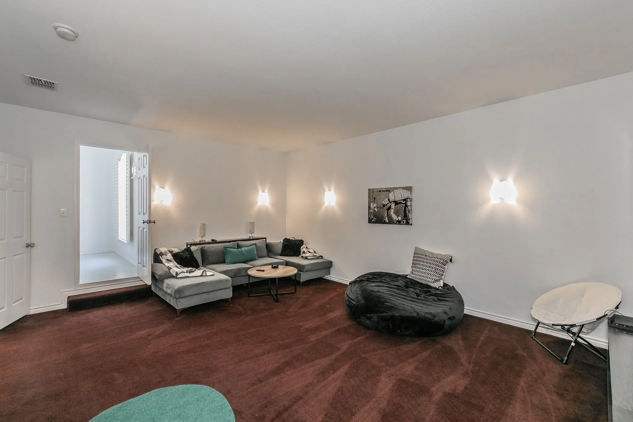 Living room with visible vents, carpet floors, and baseboards