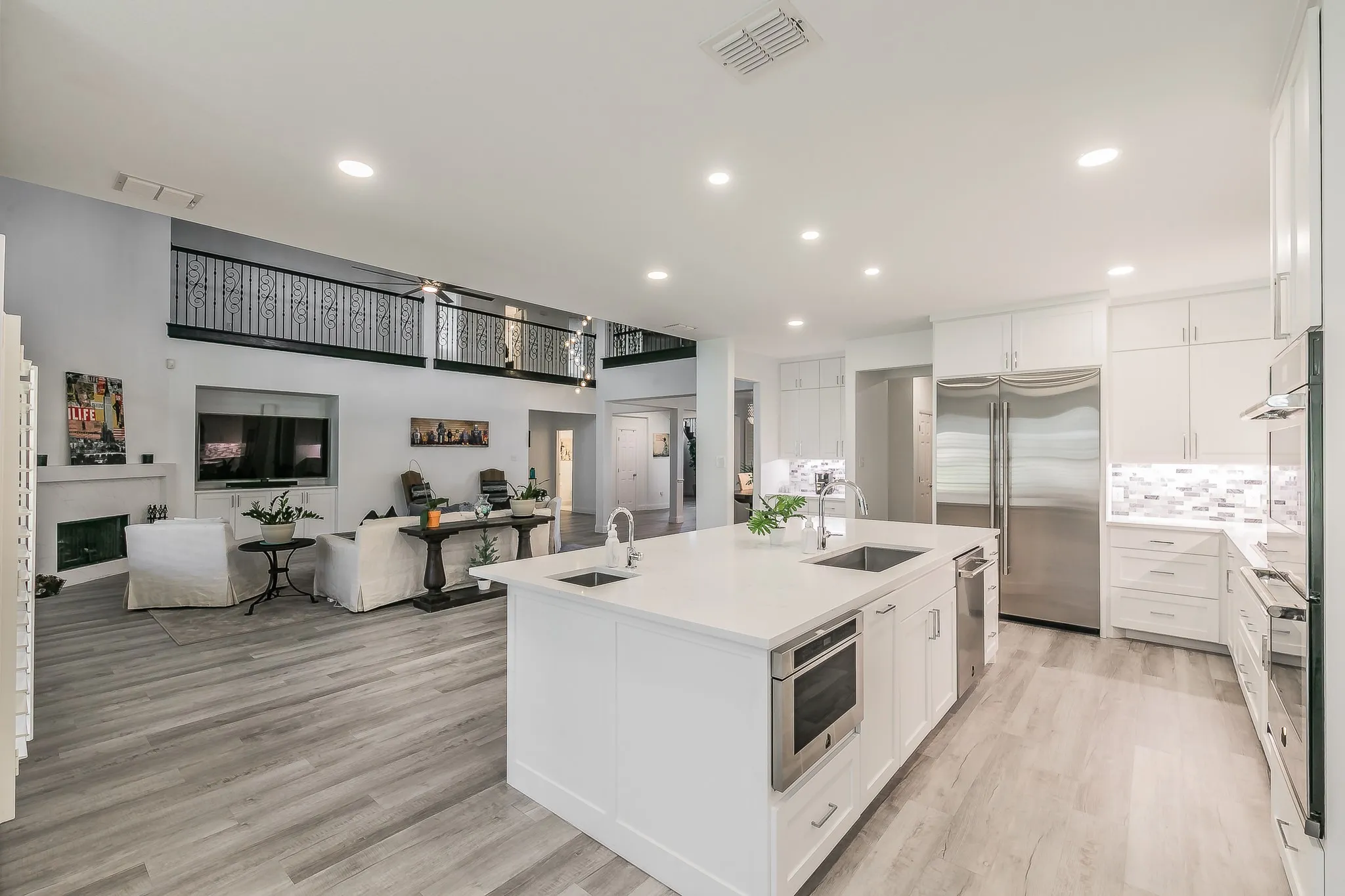 Kitchen featuring a kitchen island with sink, visible vents, stainless steel appliances, and a sink