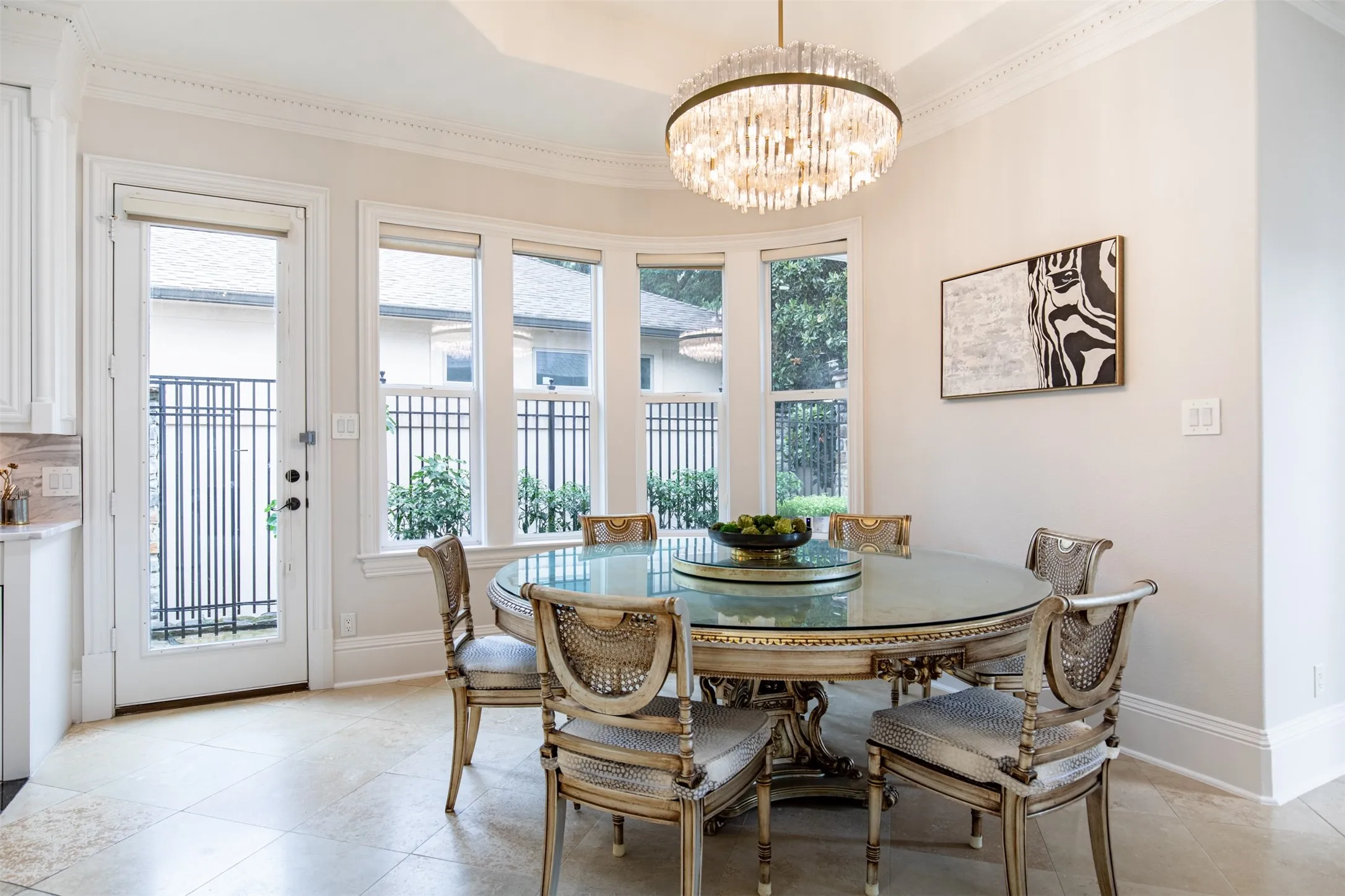 Dining area featuring a bay window with multiple panes, a glass-paneled exterior door, and tile flooring