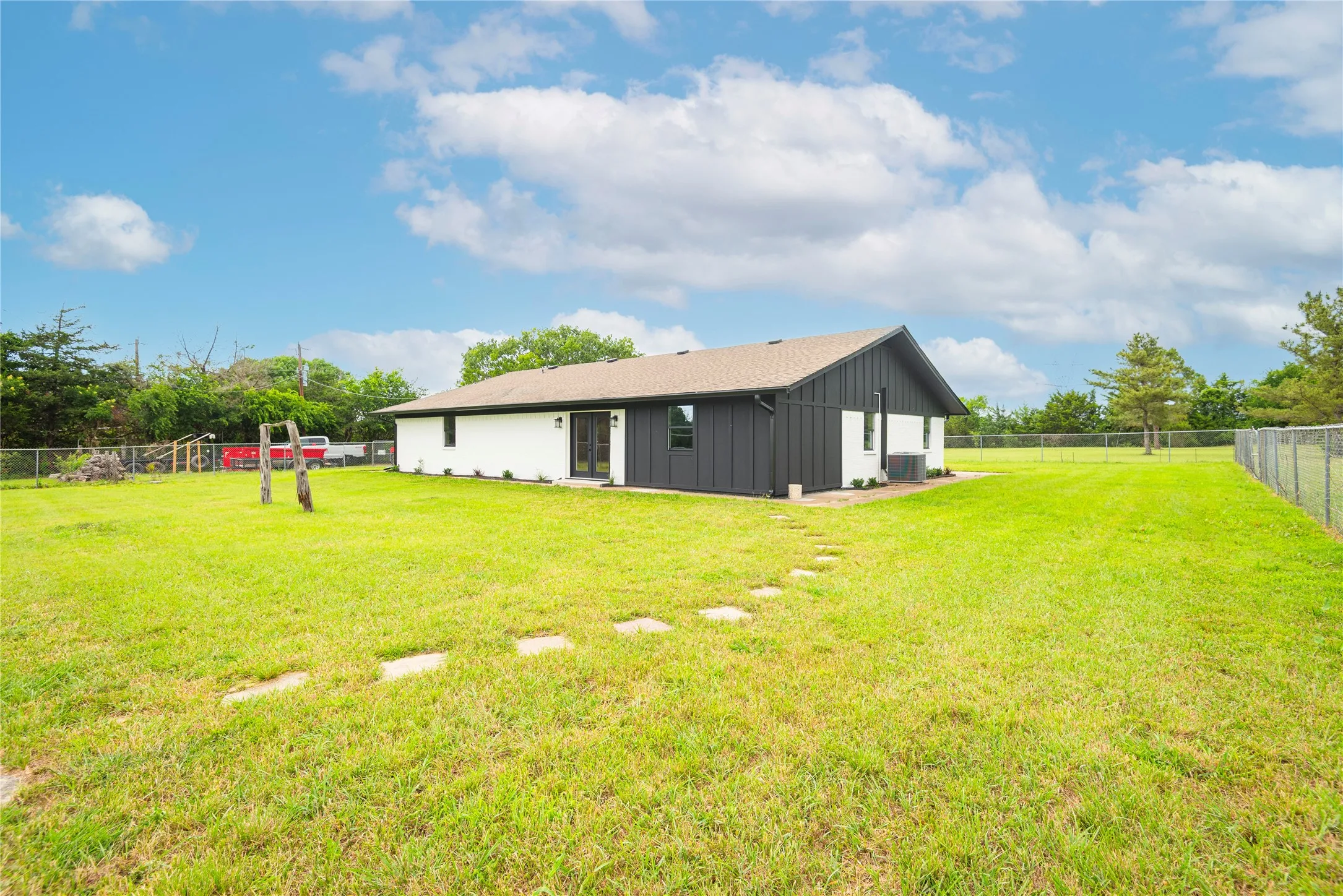 Expansive lawn with a chain-link fence perimeter