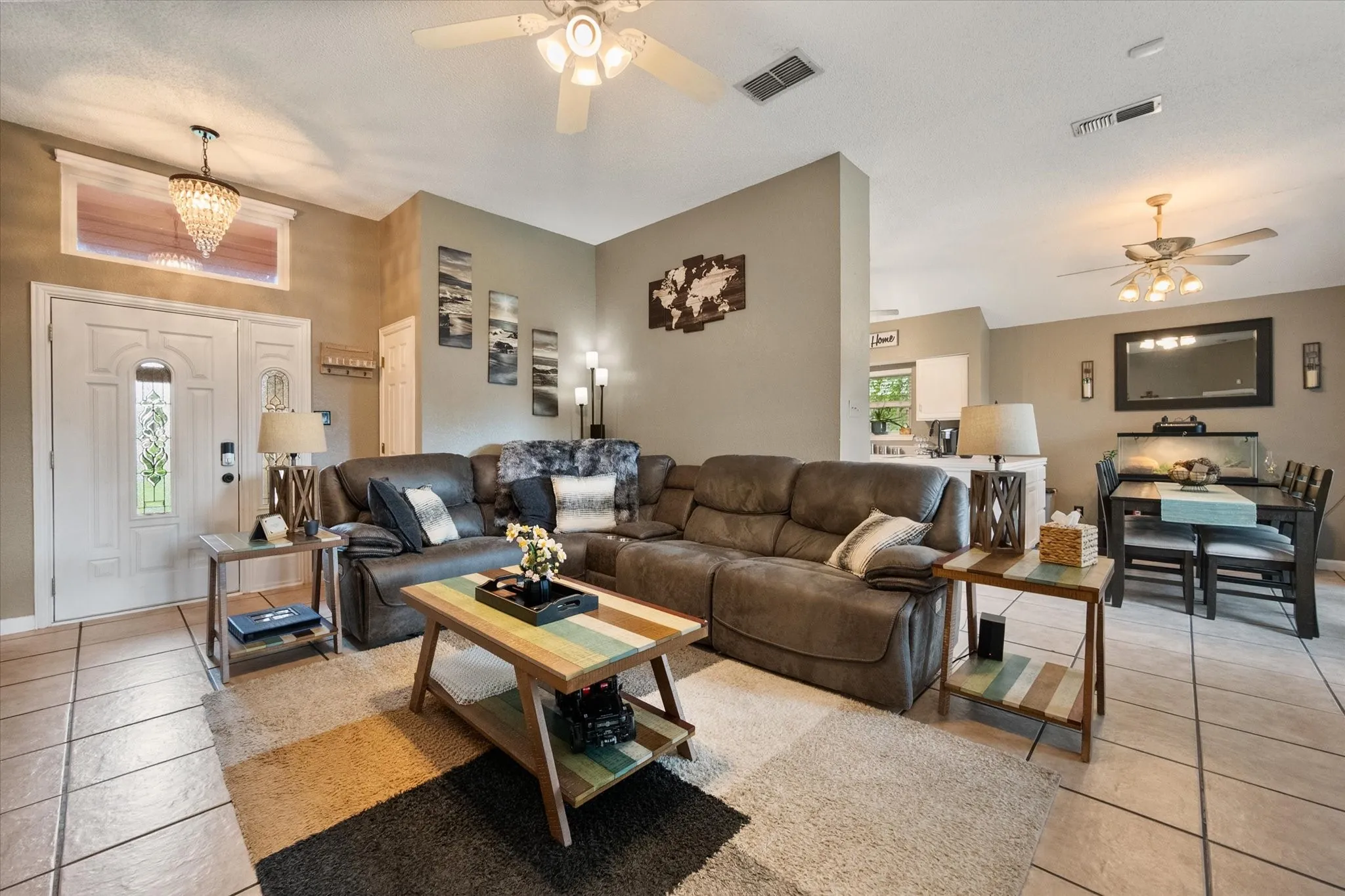 Spacious open-concept living area featuring neutral wall tones and tile flooring throughout