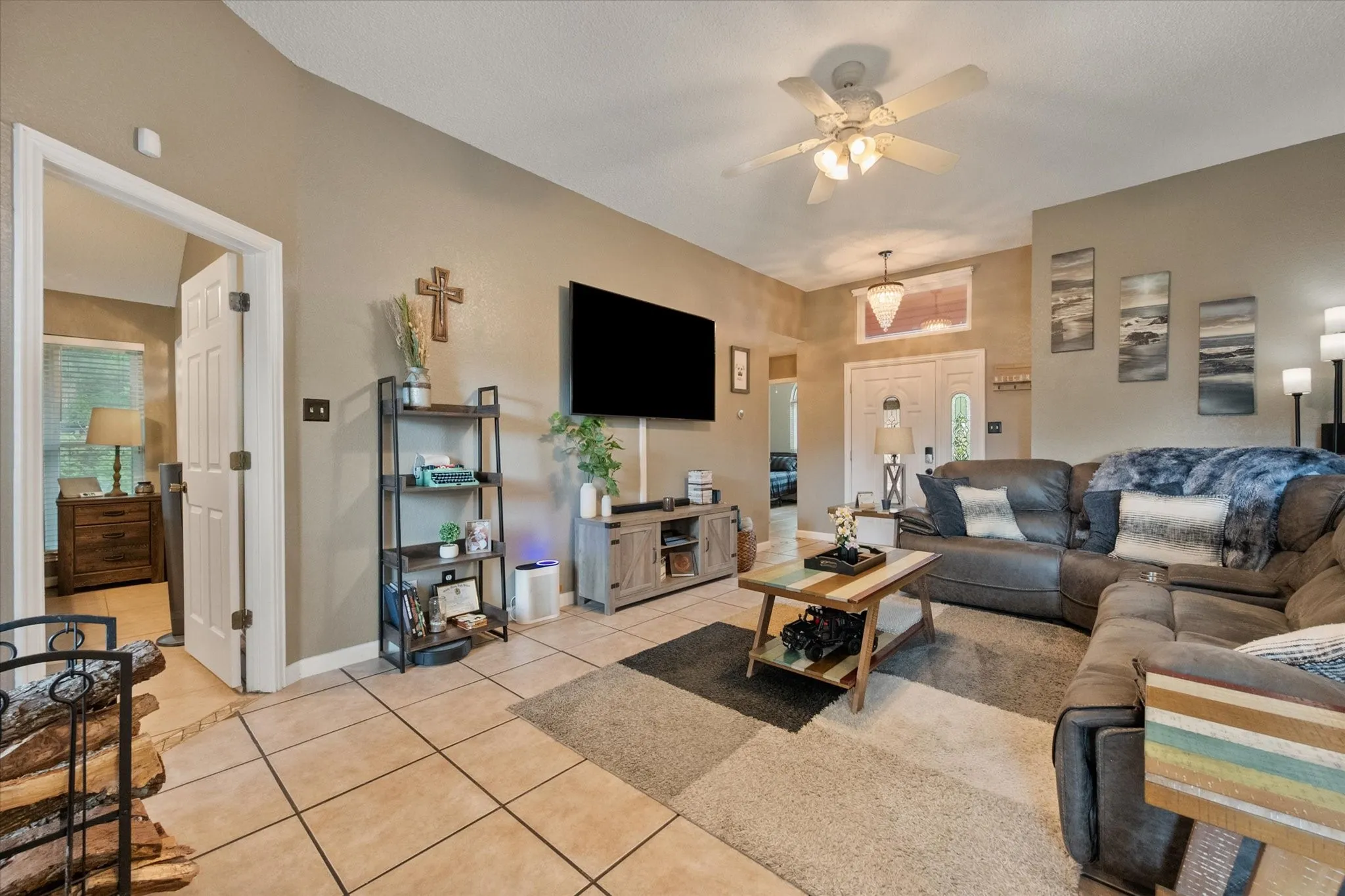 Neutral-toned walls complement ceramic tile flooring in this open-concept living area