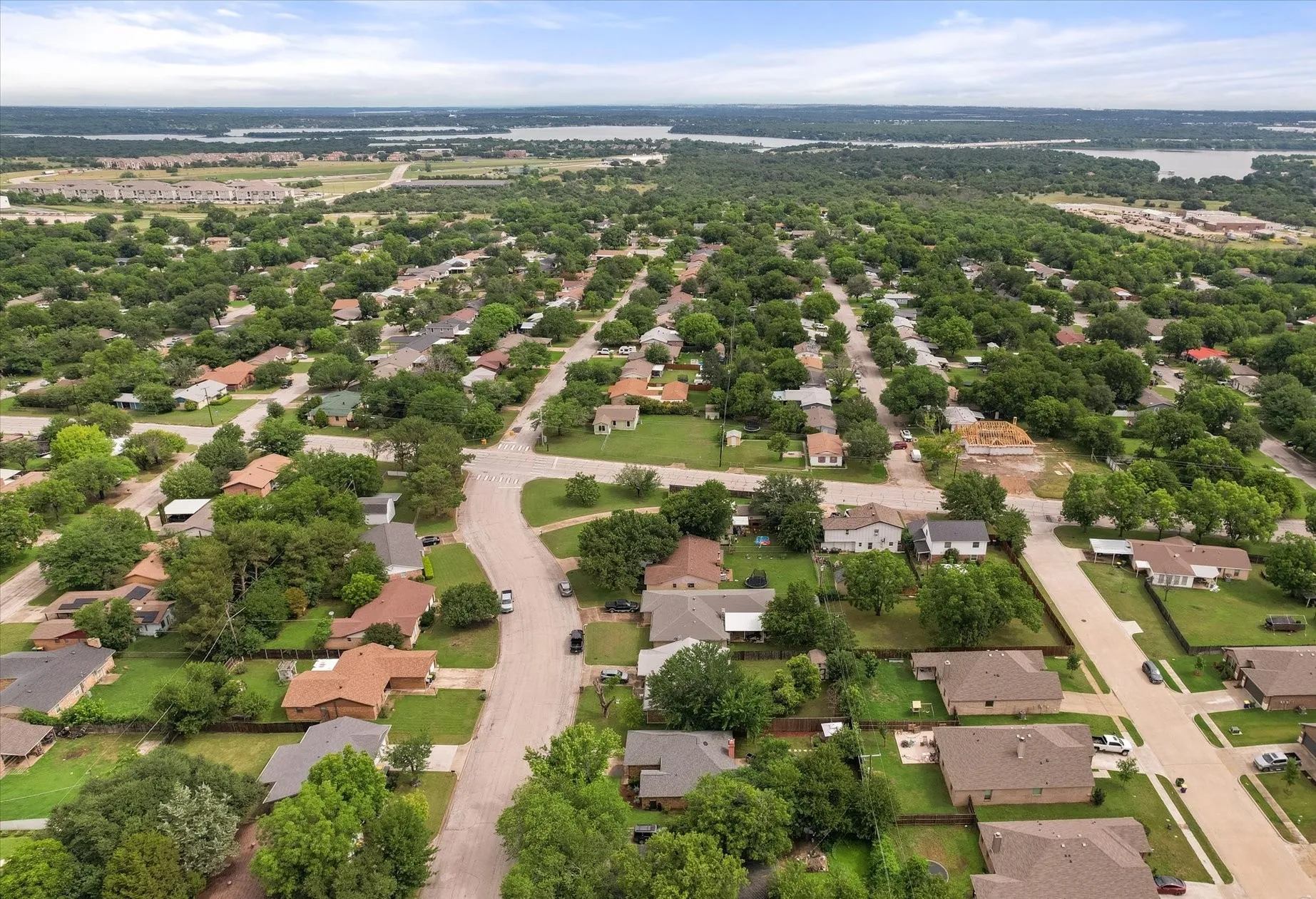 Aerial perspective showcasing a residential area characterized by mature tree canopy and established homes