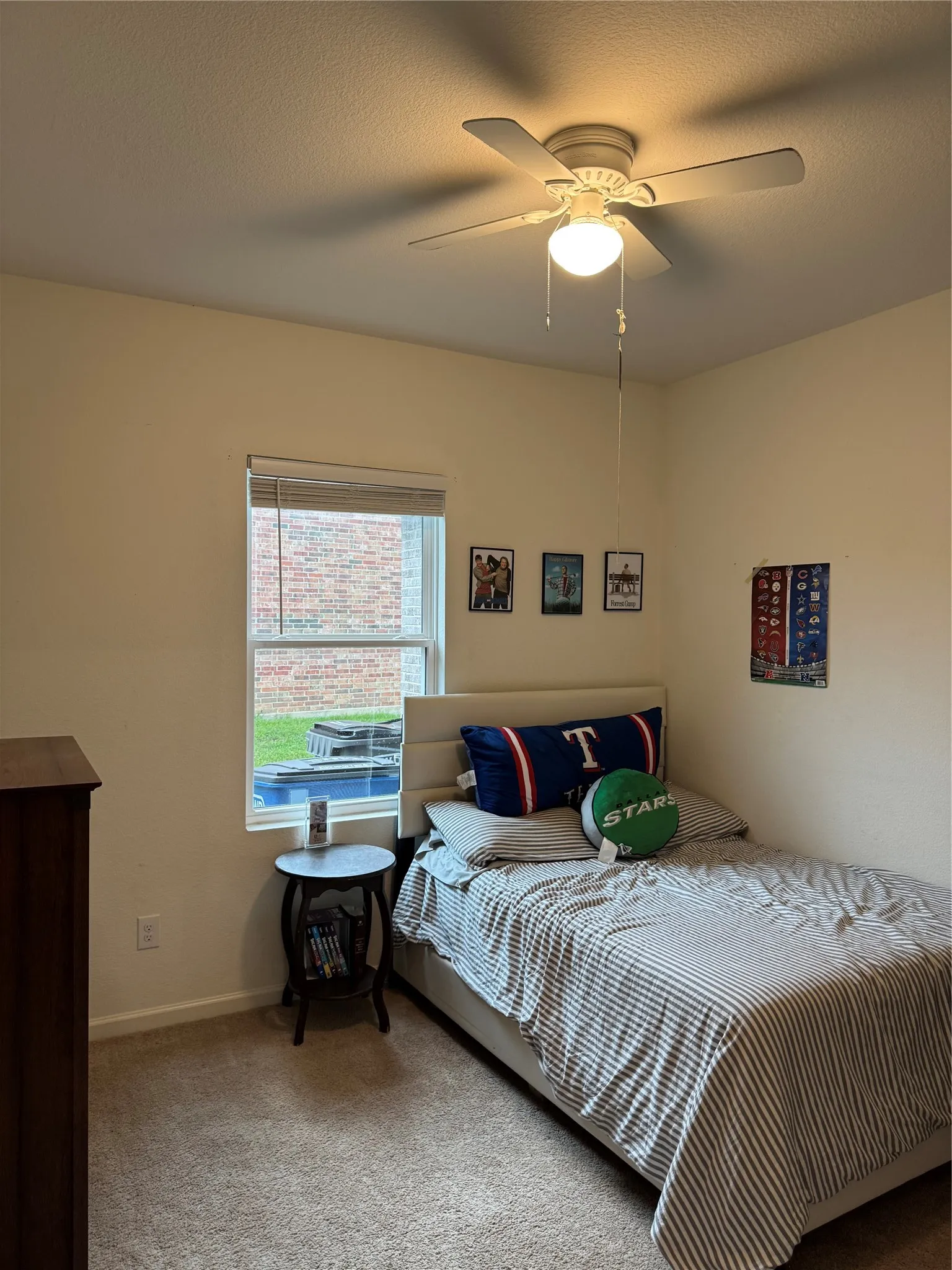 Carpeted room featuring a ceiling fan with integrated lighting, a window with blinds, and light-colored walls