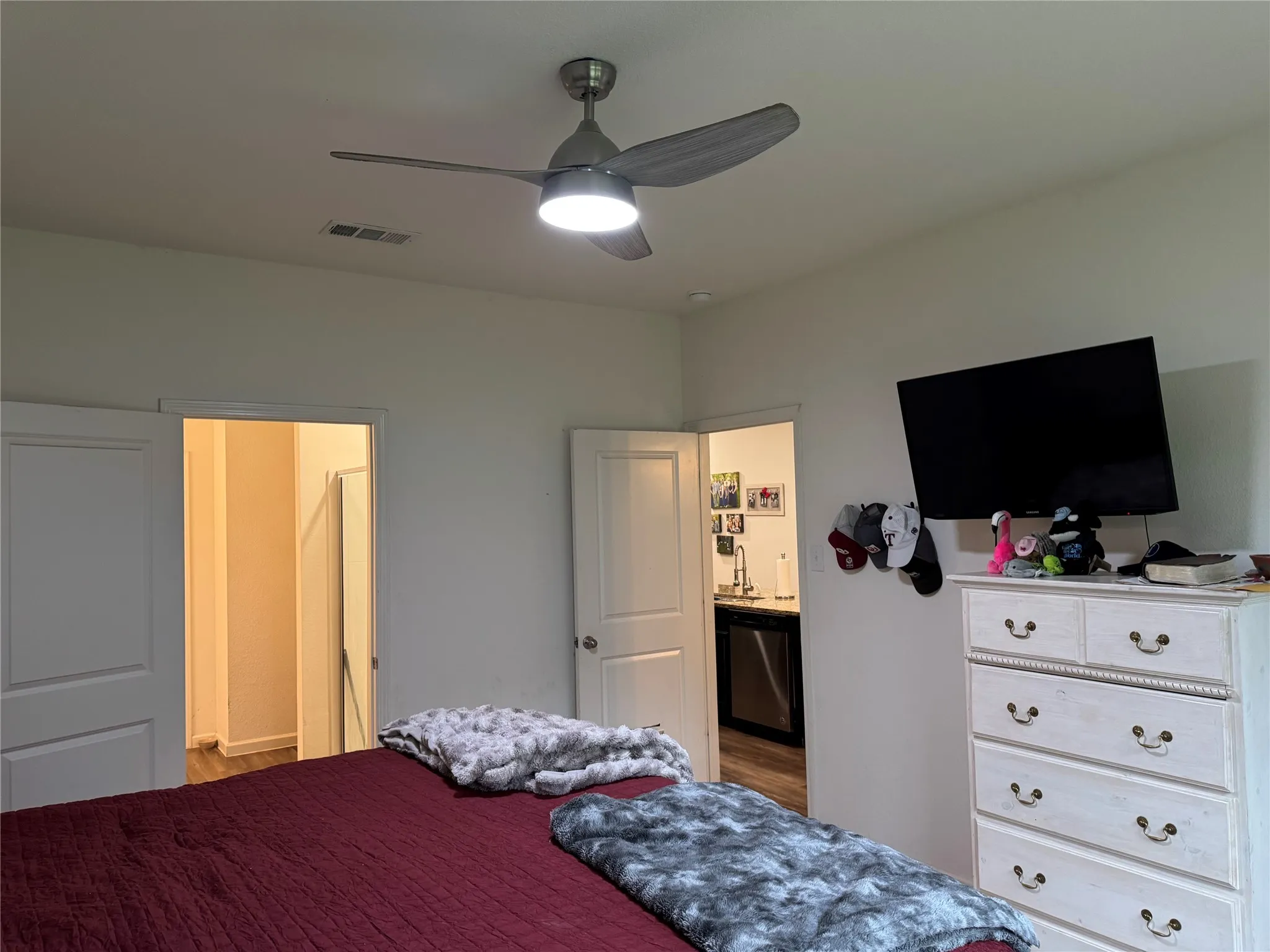 White walls featuring a ceiling fan with integrated lighting