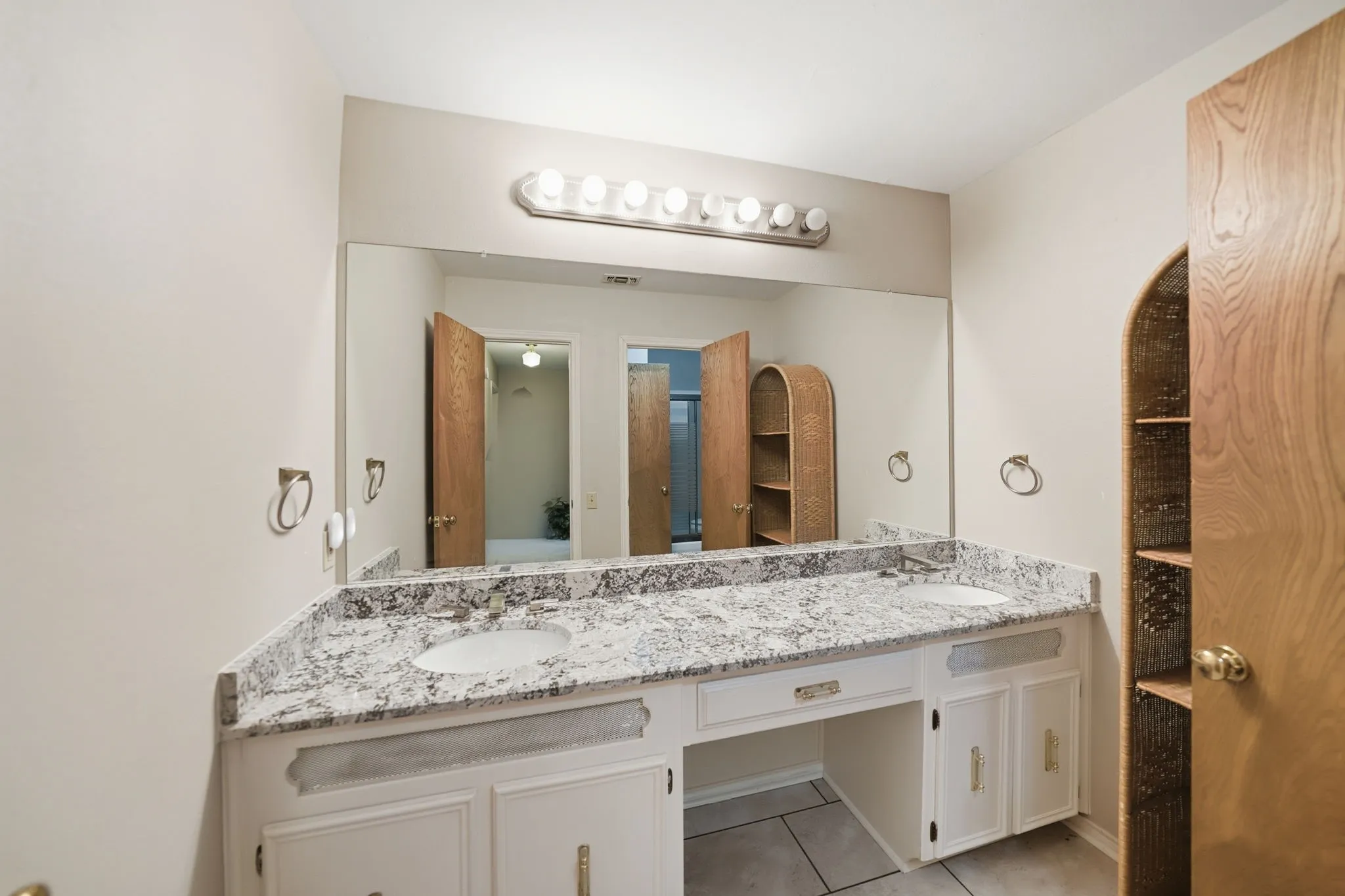 Double vanity featuring integrated sinks and a stone-finish countertop