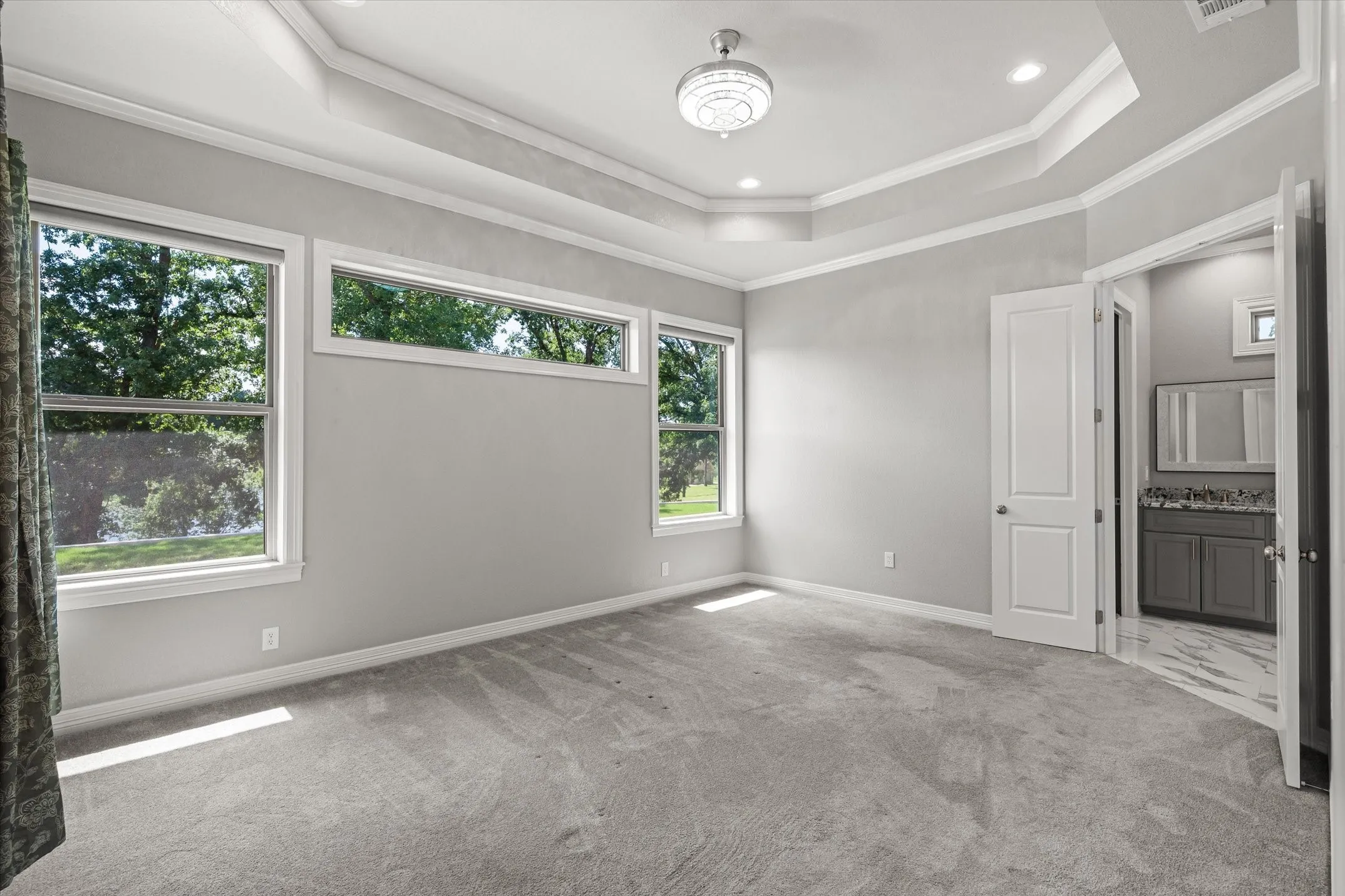 Large primary suite with lake views