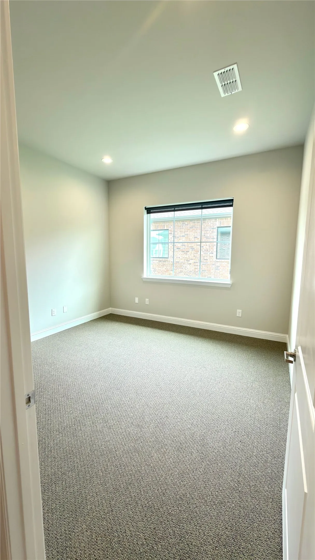 Carpeted room featuring recessed lighting, a single window, and neutral wall tones