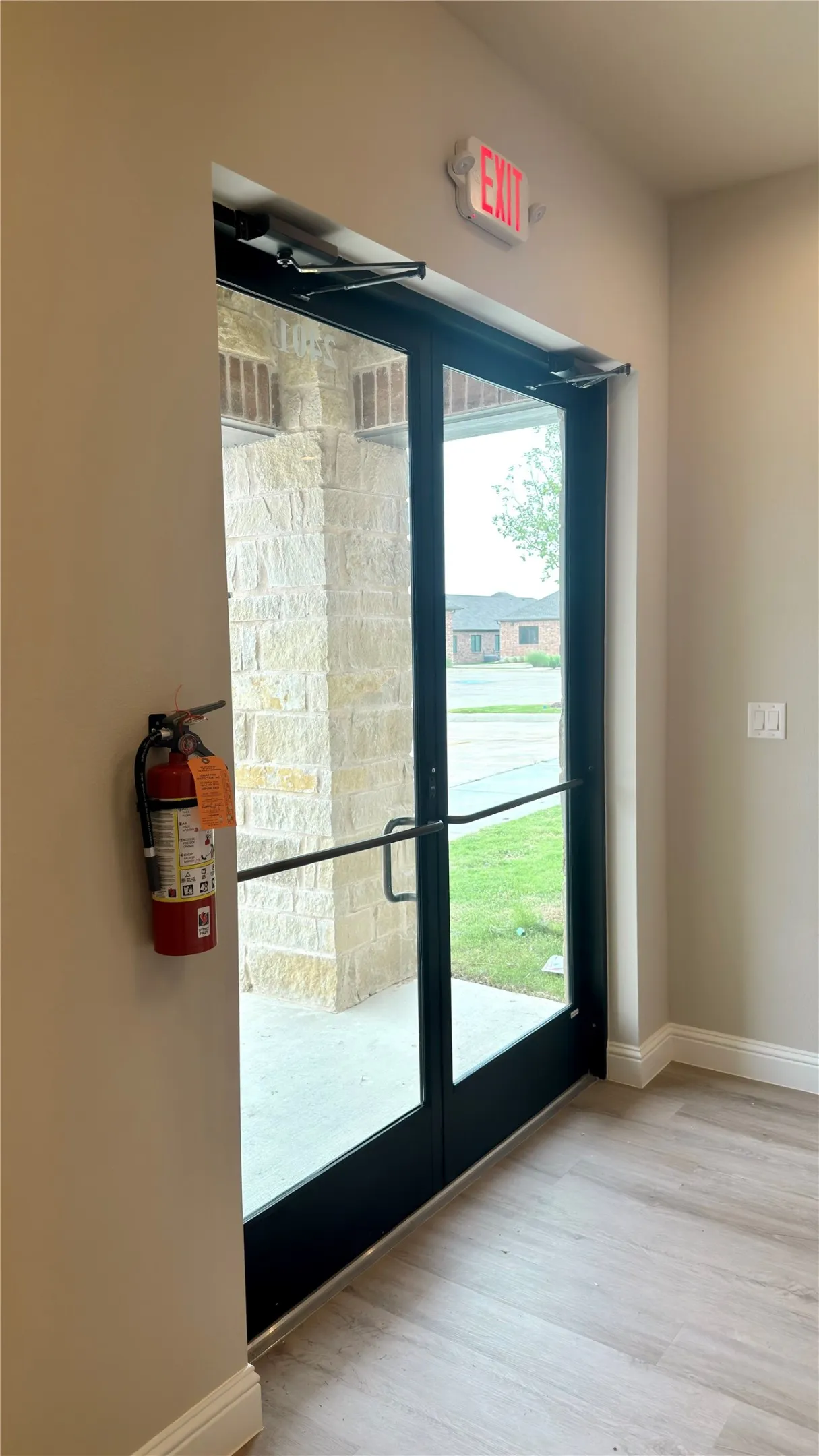 Double glass-paneled entry doors with black framing