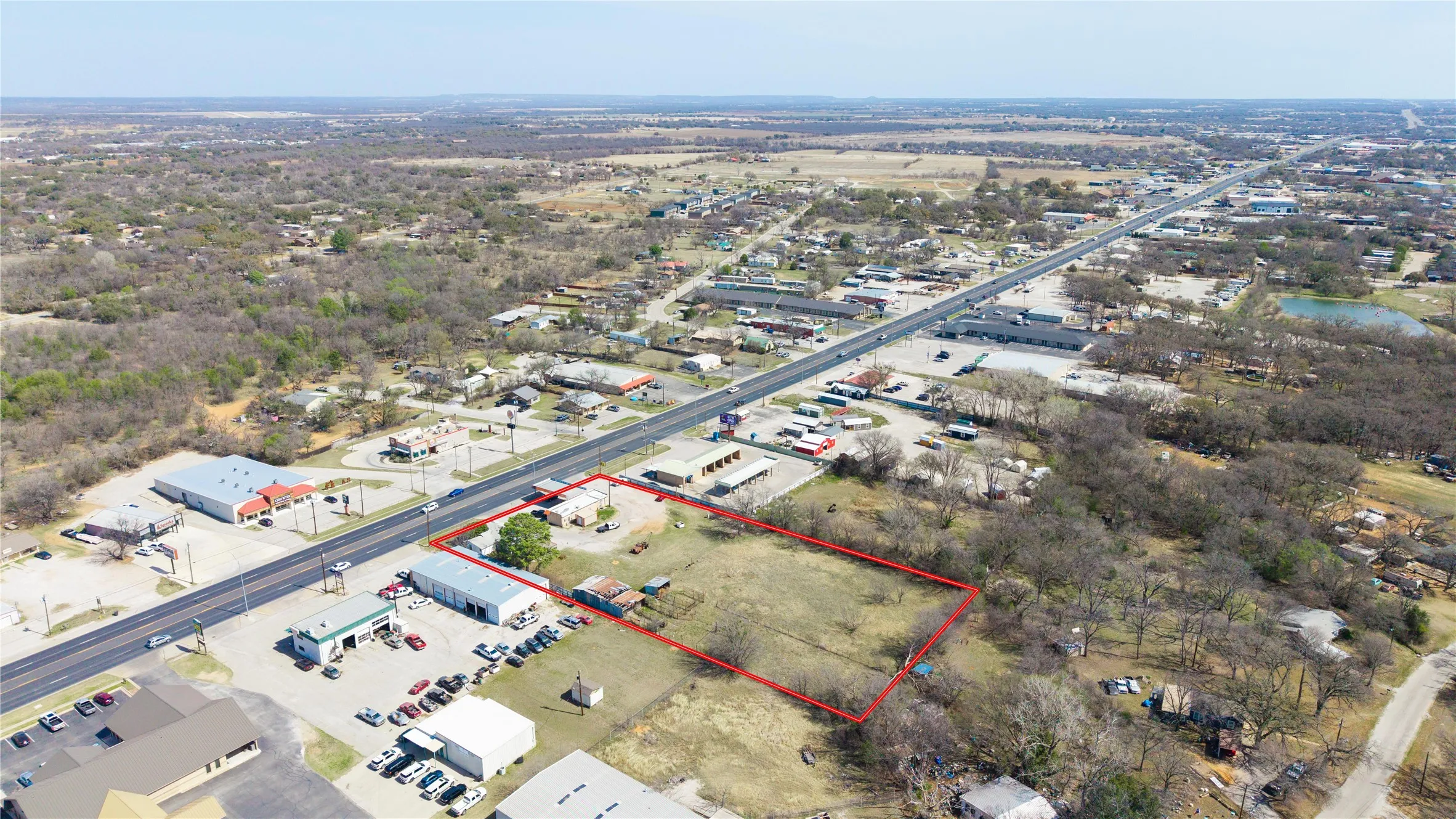 Expansive land parcel featuring direct frontage on a multi-lane highway