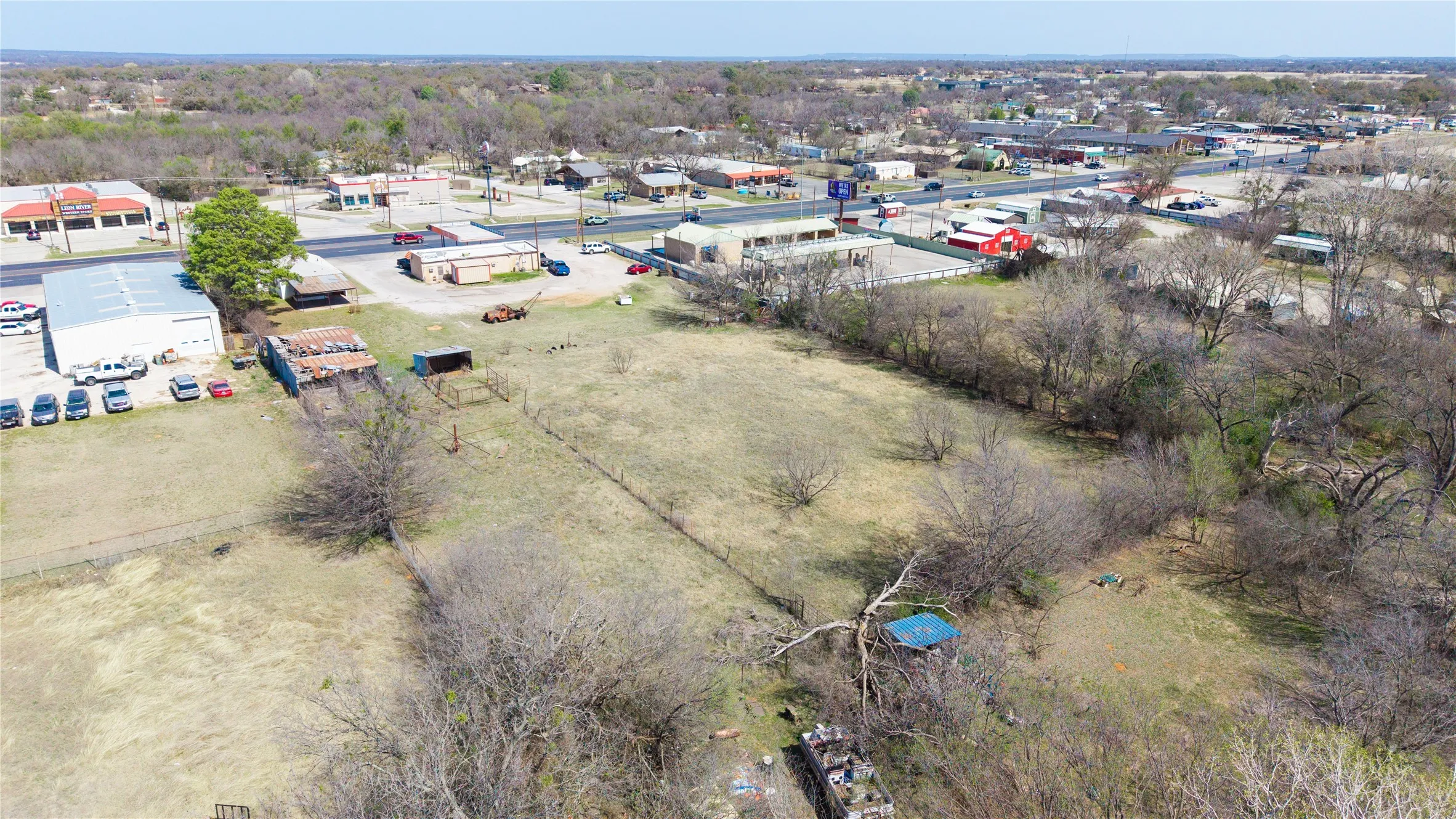 Expansive land parcel featuring open fields and mature trees