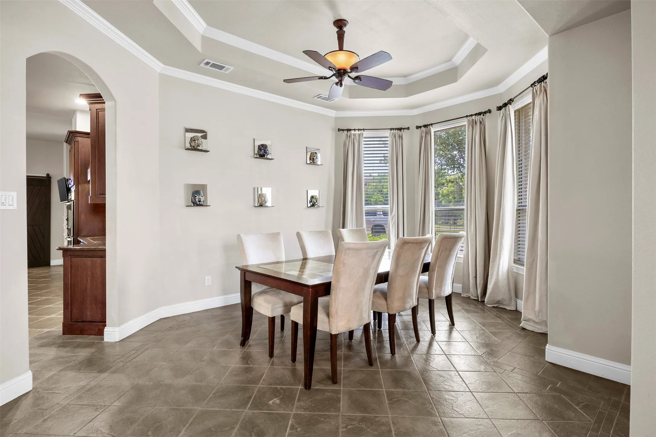 Formal dining room with large bay windows, open to kitchen and formal living room