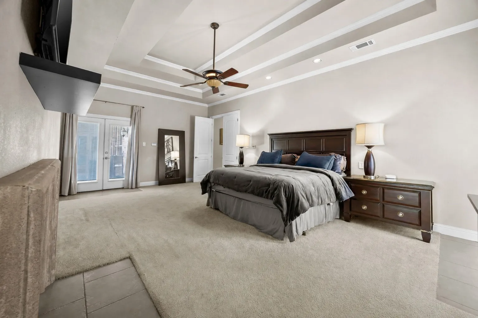 Private primary retreat with direct access to the backyard, double-sided fireplace, & an expansive layout designed for comfort, relaxation, & everyday luxury.
