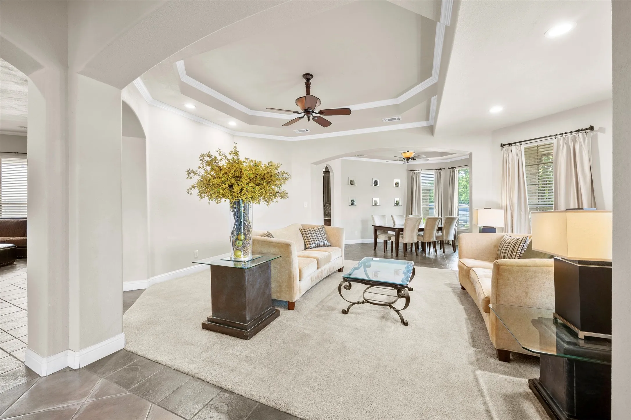 Open formal living room just off the entry featuring an inviting layout, abundant natural light, & seamless flow into the main living spaces.