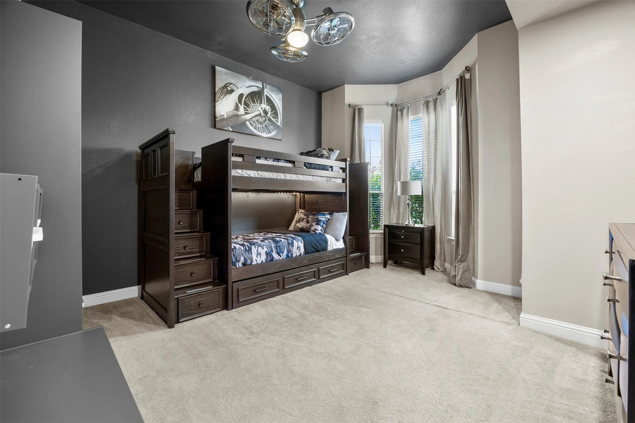 Spacious secondary bedroom with bay windows and a large walk-in closet