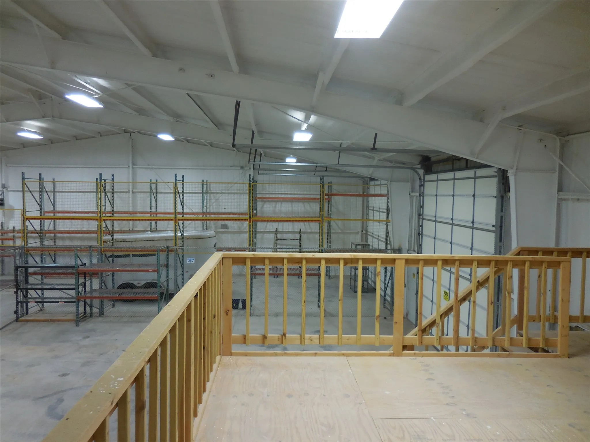 Miscellaneous room featuring vaulted ceiling and concrete floors