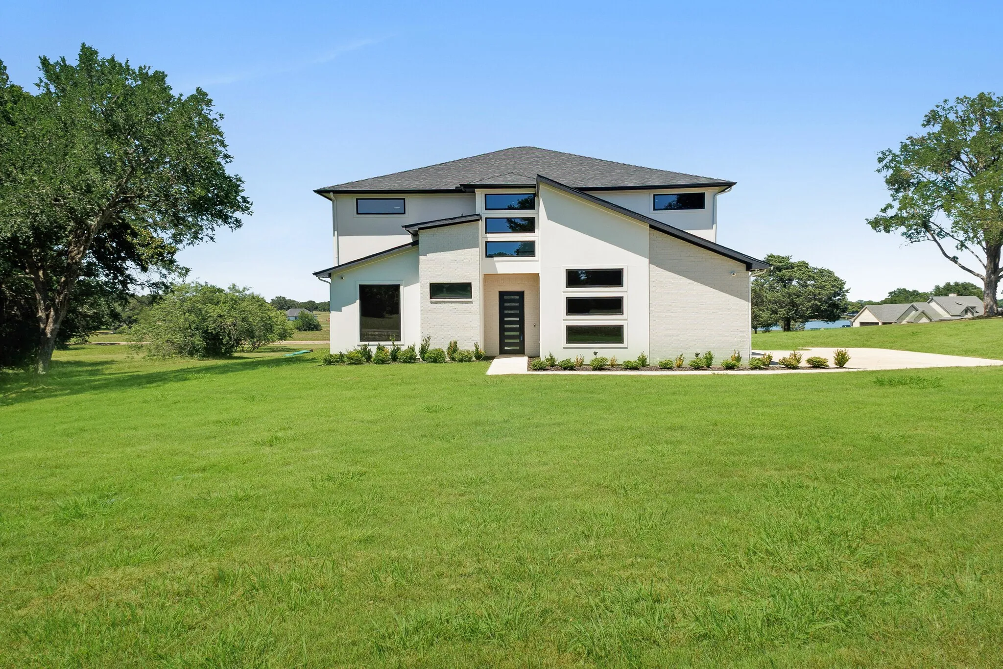 Modern two-story stucco exterior with a dark-pitched roof