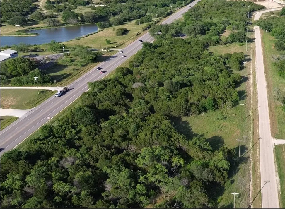 Expansive land parcel featuring tree cover and clearings on Lot #95 towards the bottom of the photo