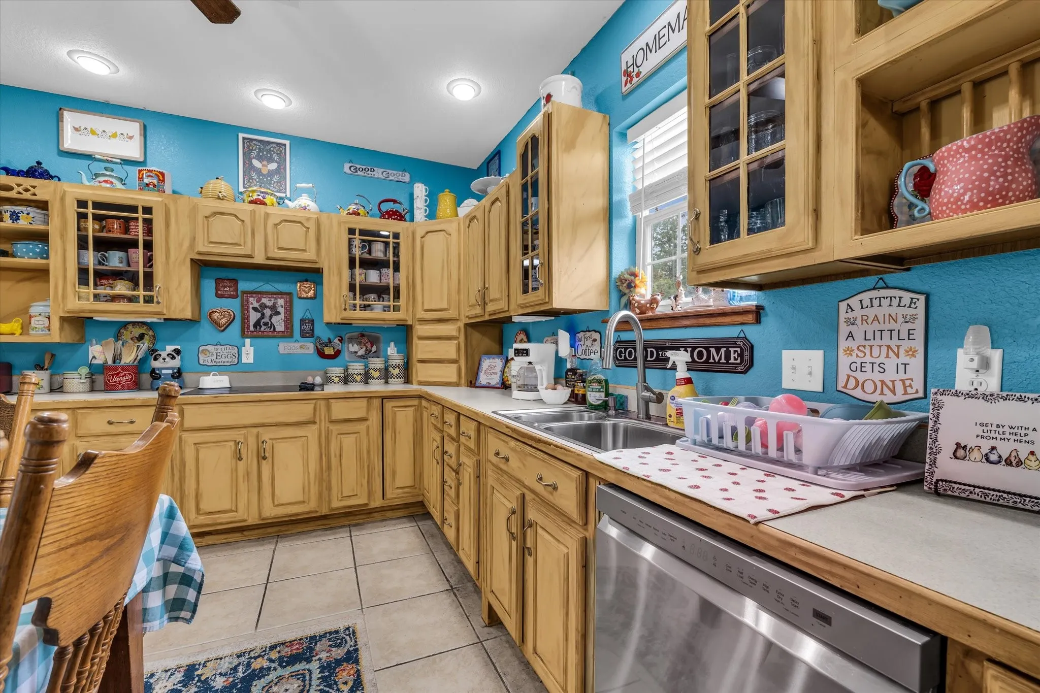 Kitchen featuring wood-finish cabinetry, a stainless steel dishwasher, a double basin sink, and recessed ceiling lighting