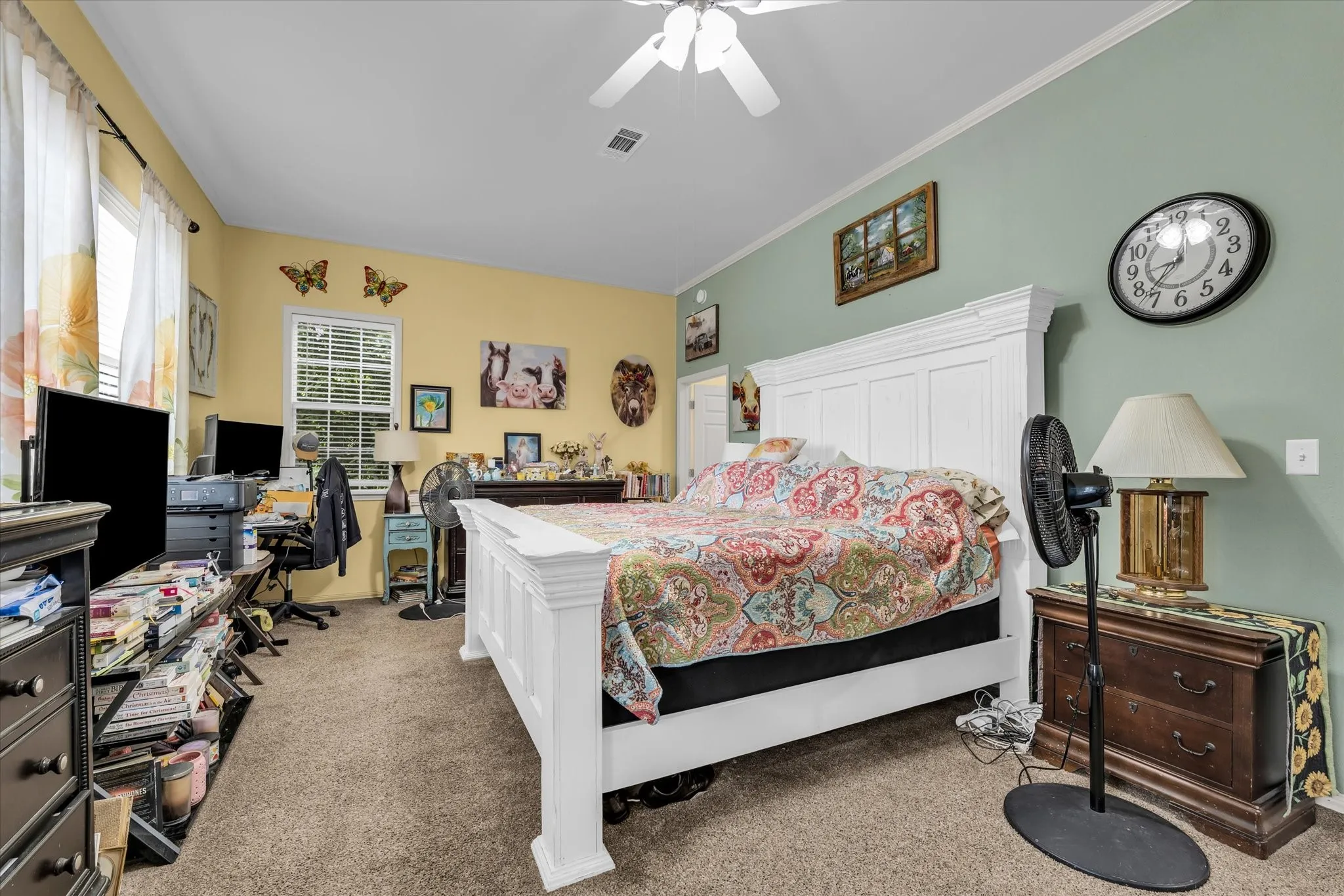 Carpeted room featuring a white ceiling fan, multi-tone wall paint, and a window with blinds