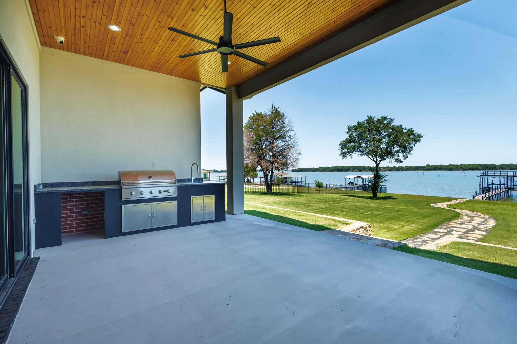 Covered outdoor patio featuring a wood-finish ceiling with recessed lighting and a ceiling fan