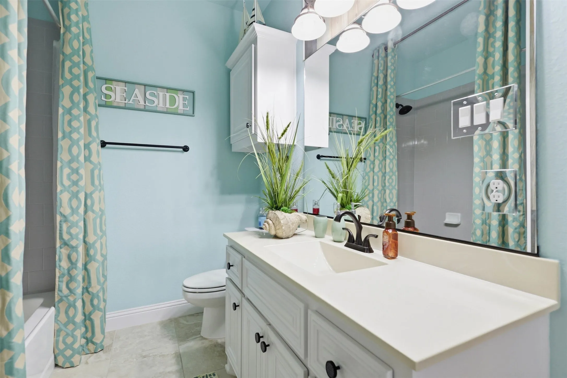 White vanity with integrated rectangular sink and oil-rubbed bronze faucet