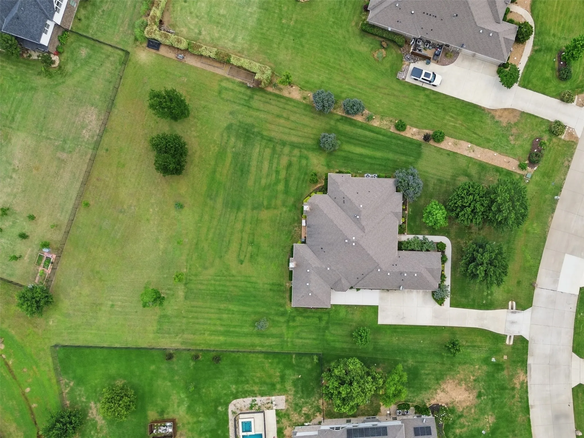 Aerial perspective showcasing a single-story residence with a gray-shingled roof