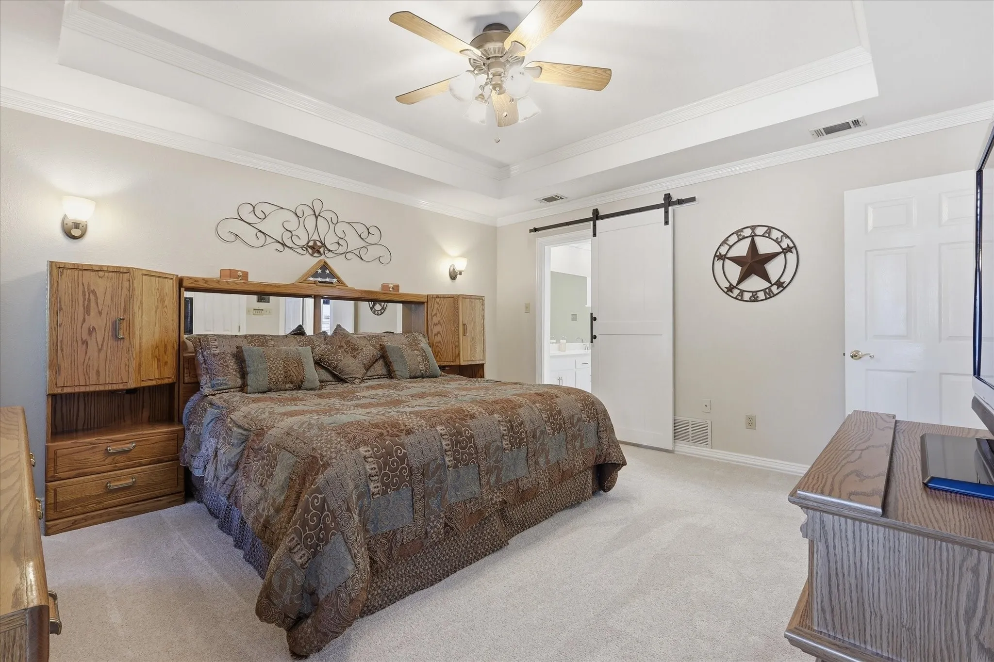 Tray ceiling featuring a ceiling fan with integrated lighting
