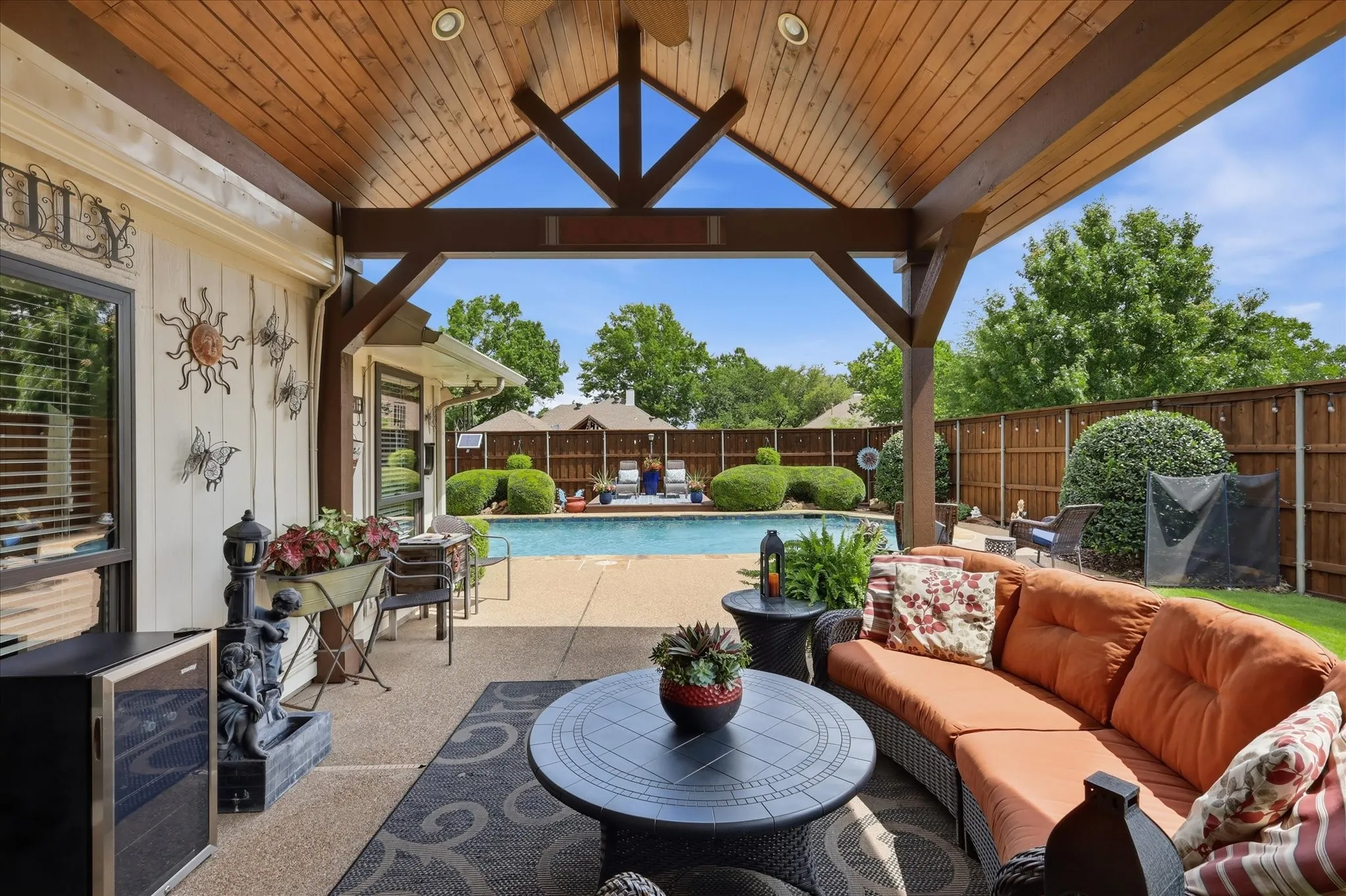 Covered patio featuring a high vaulted wood ceiling, exposed beams, and recessed lighting