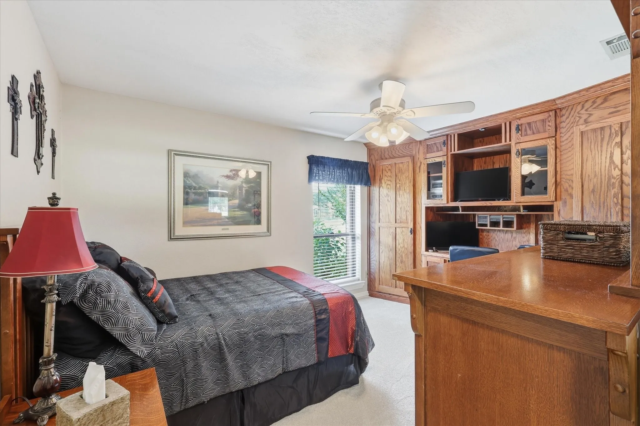 Built-in wood cabinetry and desk system featuring glass-front cabinets and integrated shelving