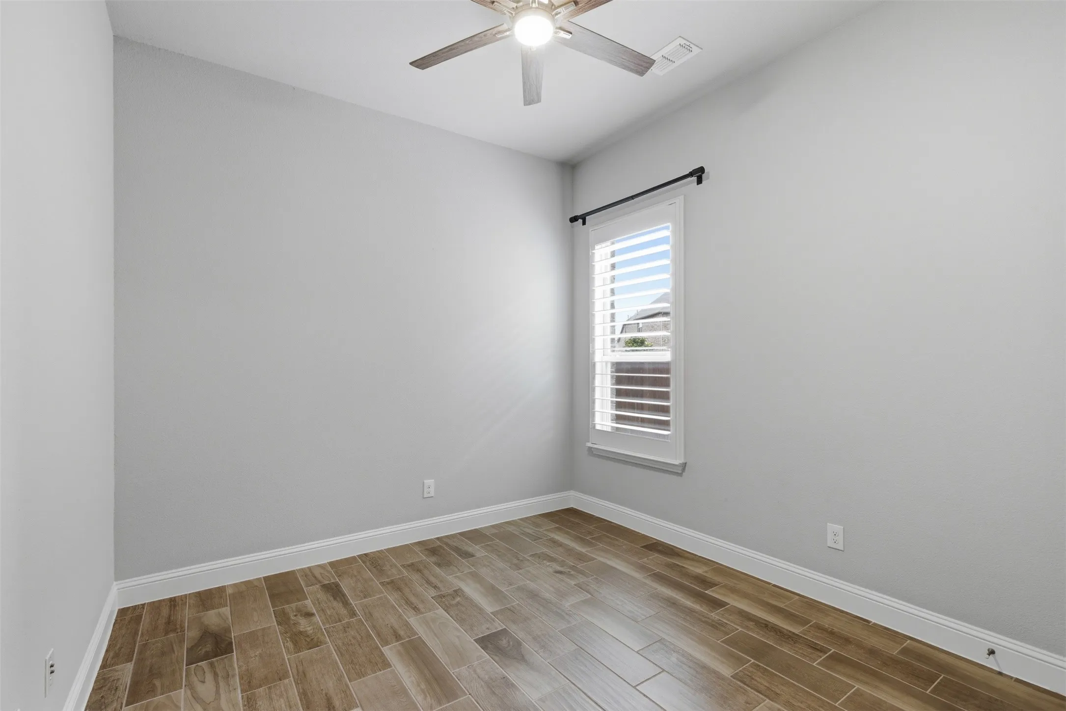 First Floor Secondary Bedrooms: Neutral paint tones complemented by wood-finish flooring