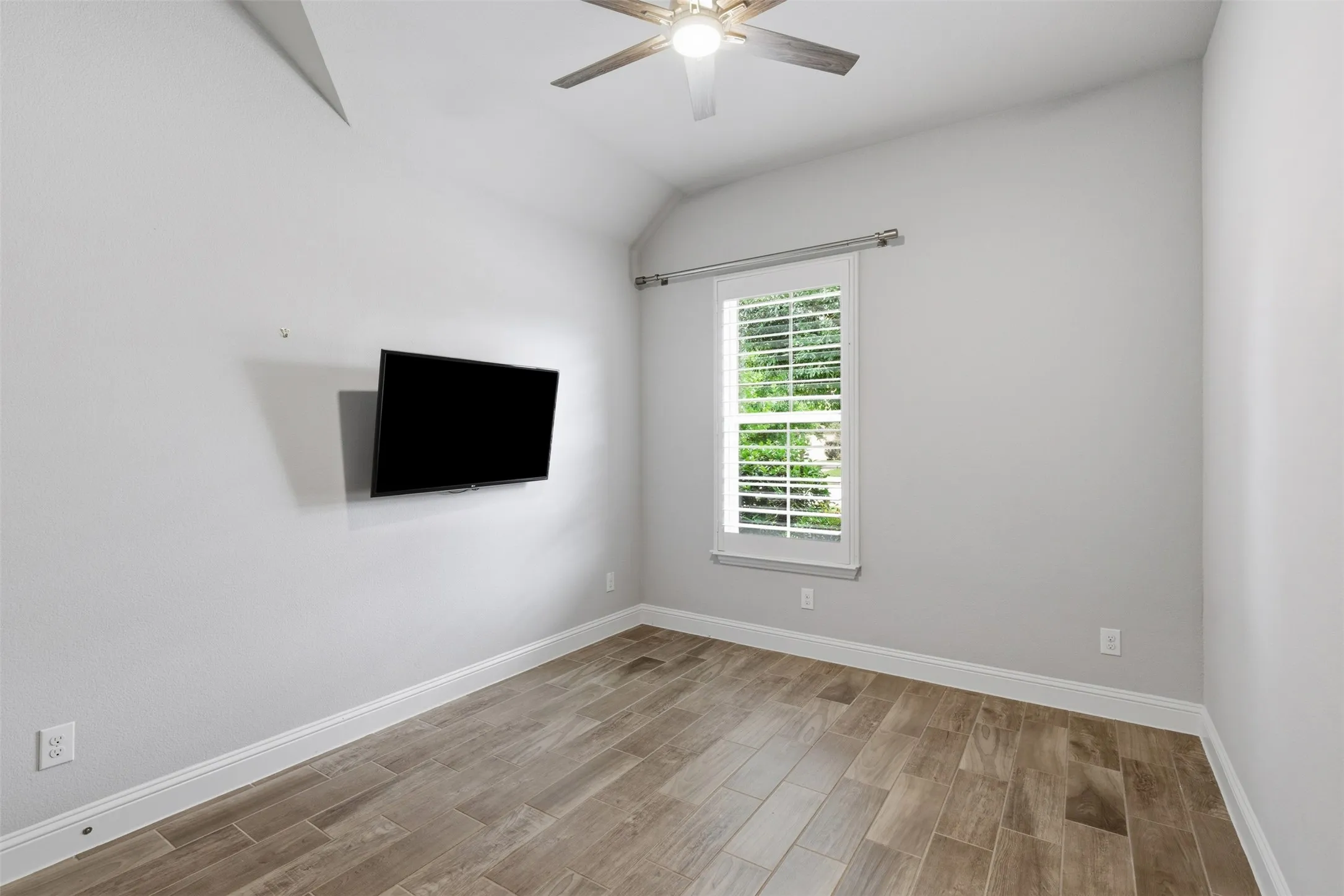 1st floor secondary bedroom with vaulted ceiling and plantation shutters