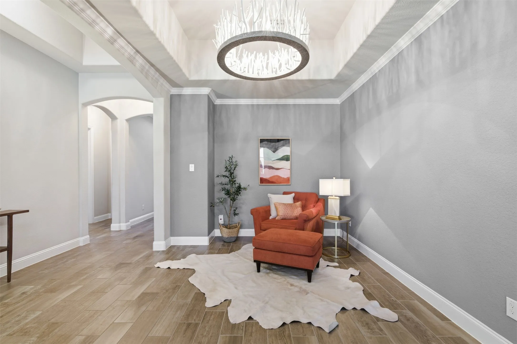 Tray ceiling featuring a unique chandelier in the formal dining room