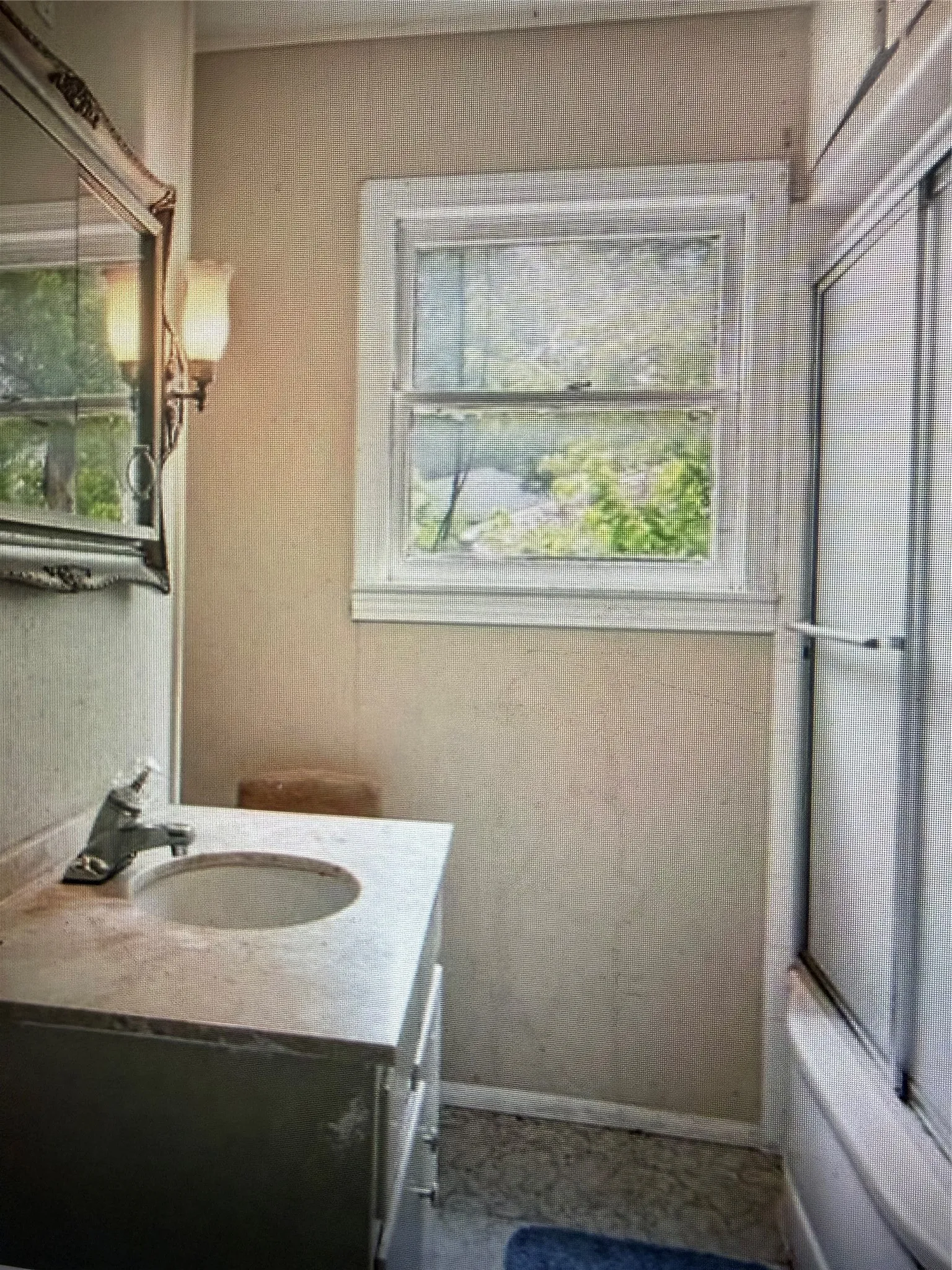 Bathroom featuring a single window, a vanity with an integrated sink, and a built-in shower/tub combination