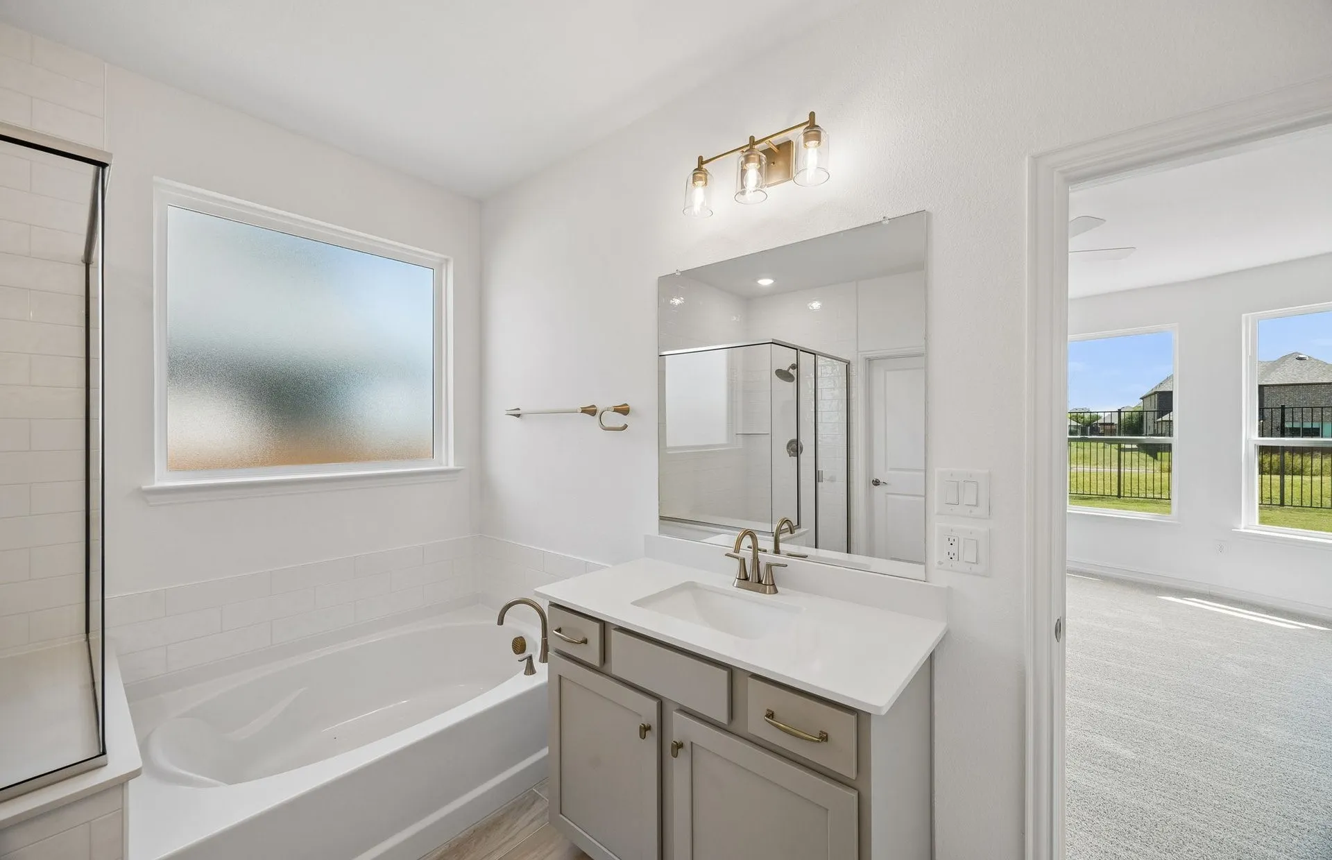 Separate vanities in owner's bath