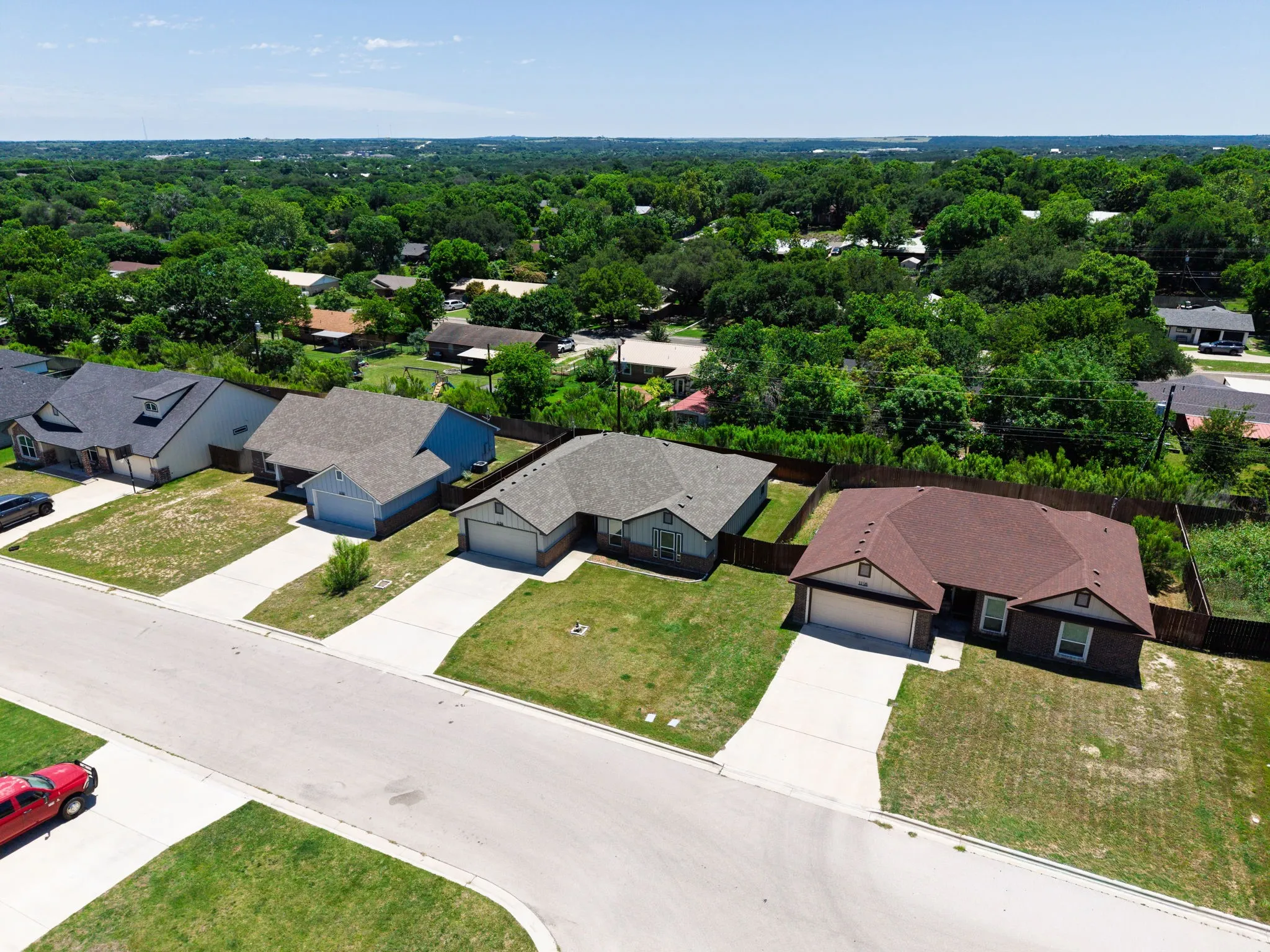 Single-story residence featuring a brown shingle roof and a two-car garage
