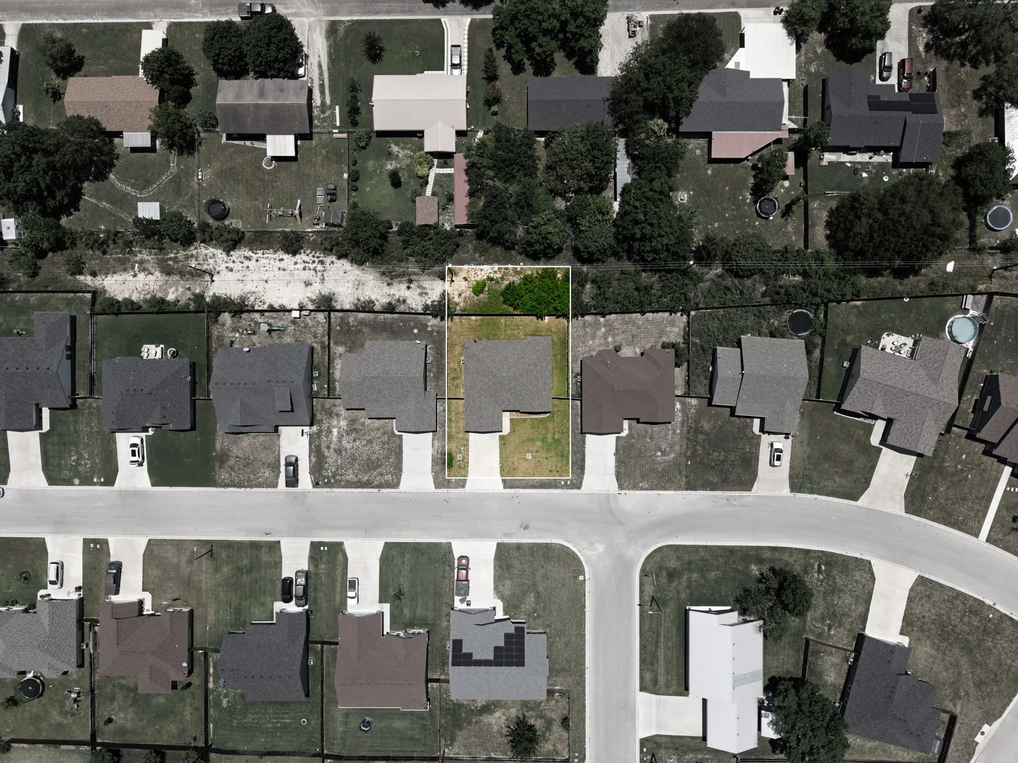 Aerial perspective showcasing a residential property with a green lawn