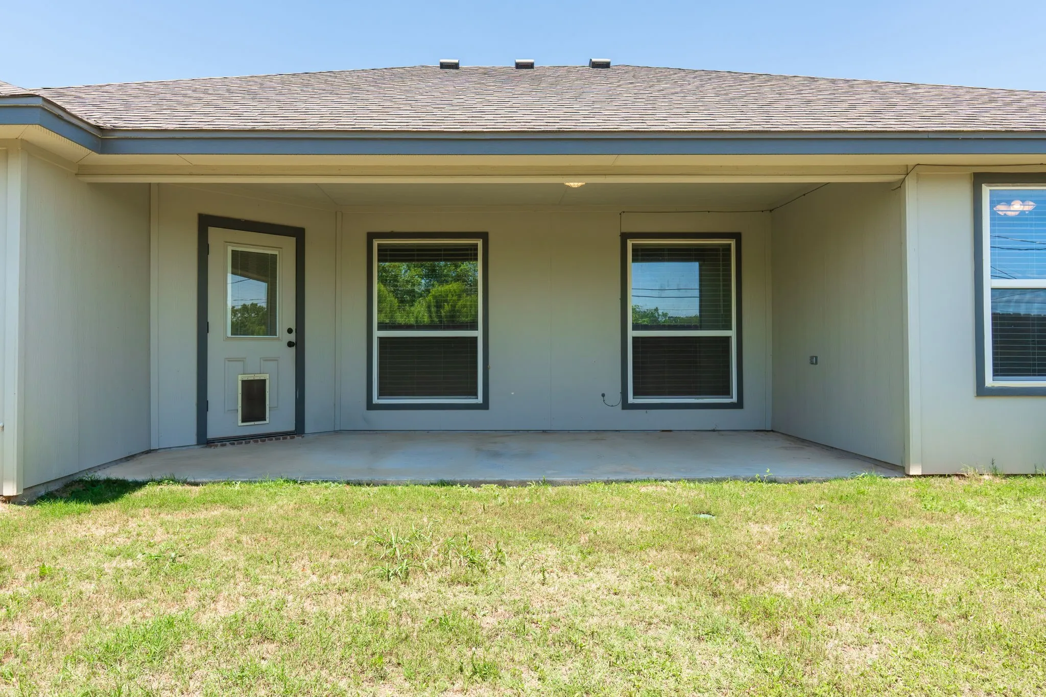 Covered patio featuring a concrete slab and direct backyard access
