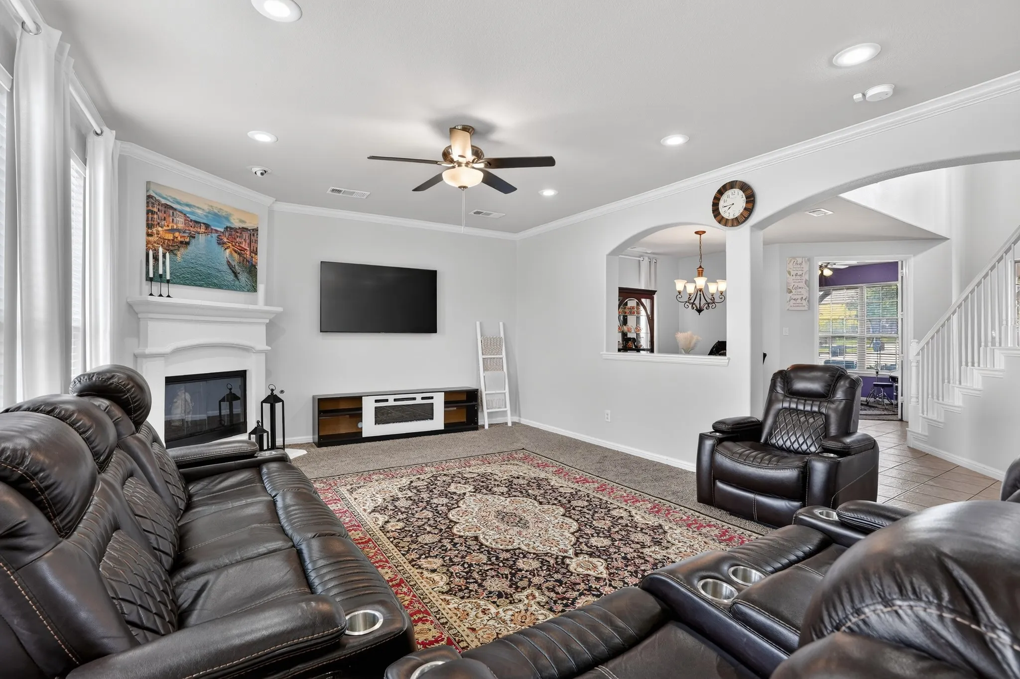 Living area featuring a white mantel fireplace, recessed lighting, and a ceiling fan