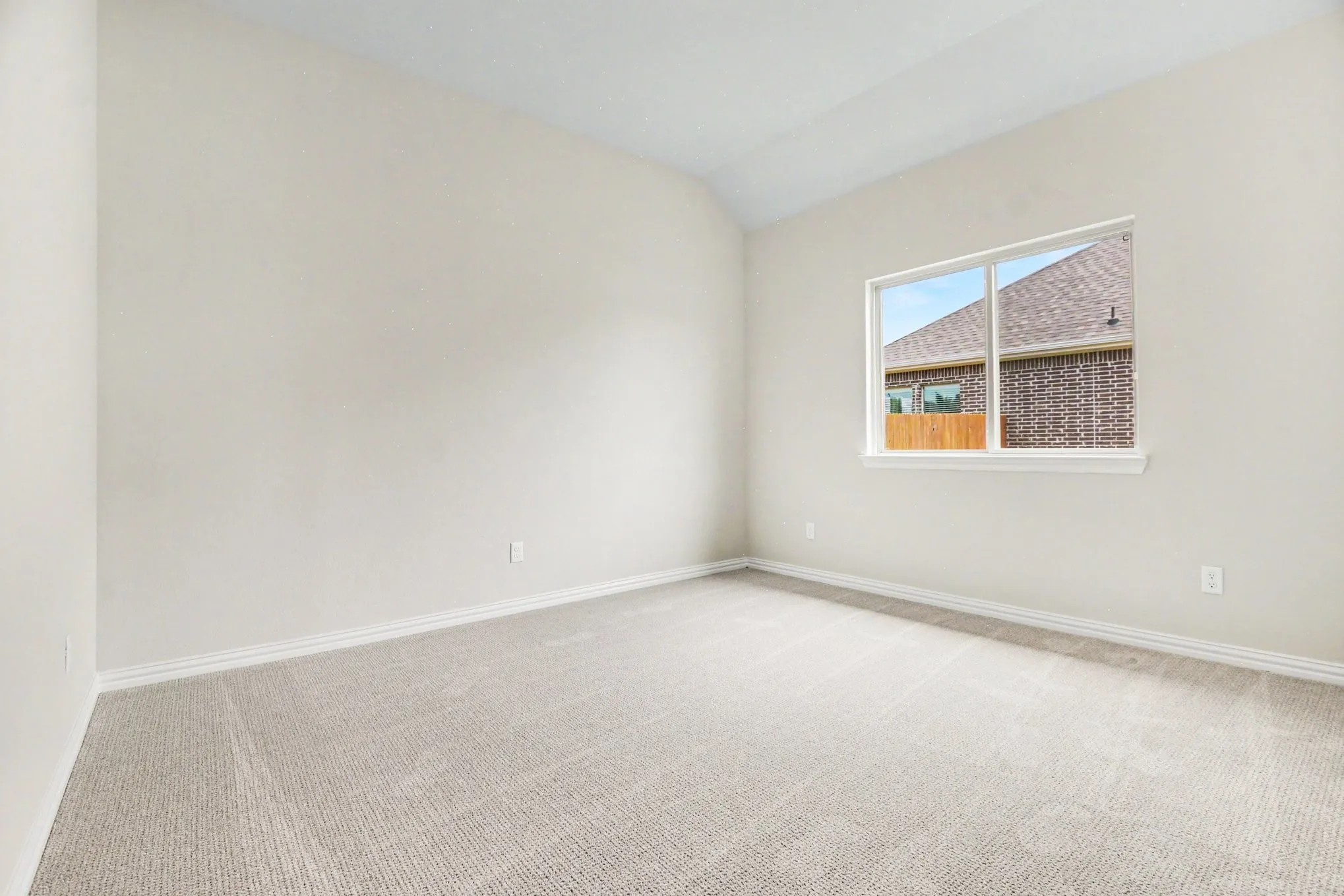 Neutral-toned room featuring light-colored walls and wall-to-wall carpeting