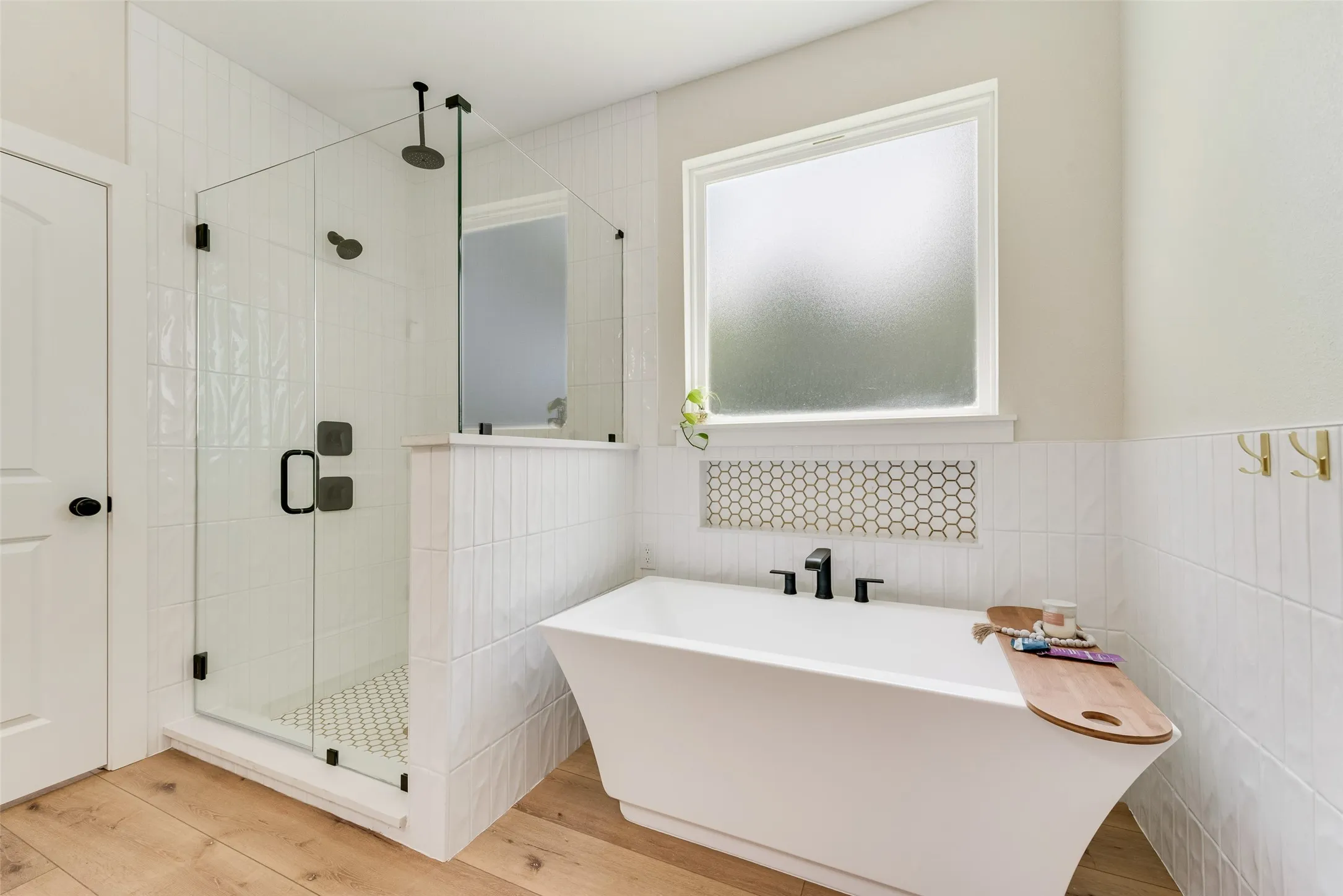 Modern bathroom featuring a freestanding soaking tub and a glass-enclosed shower