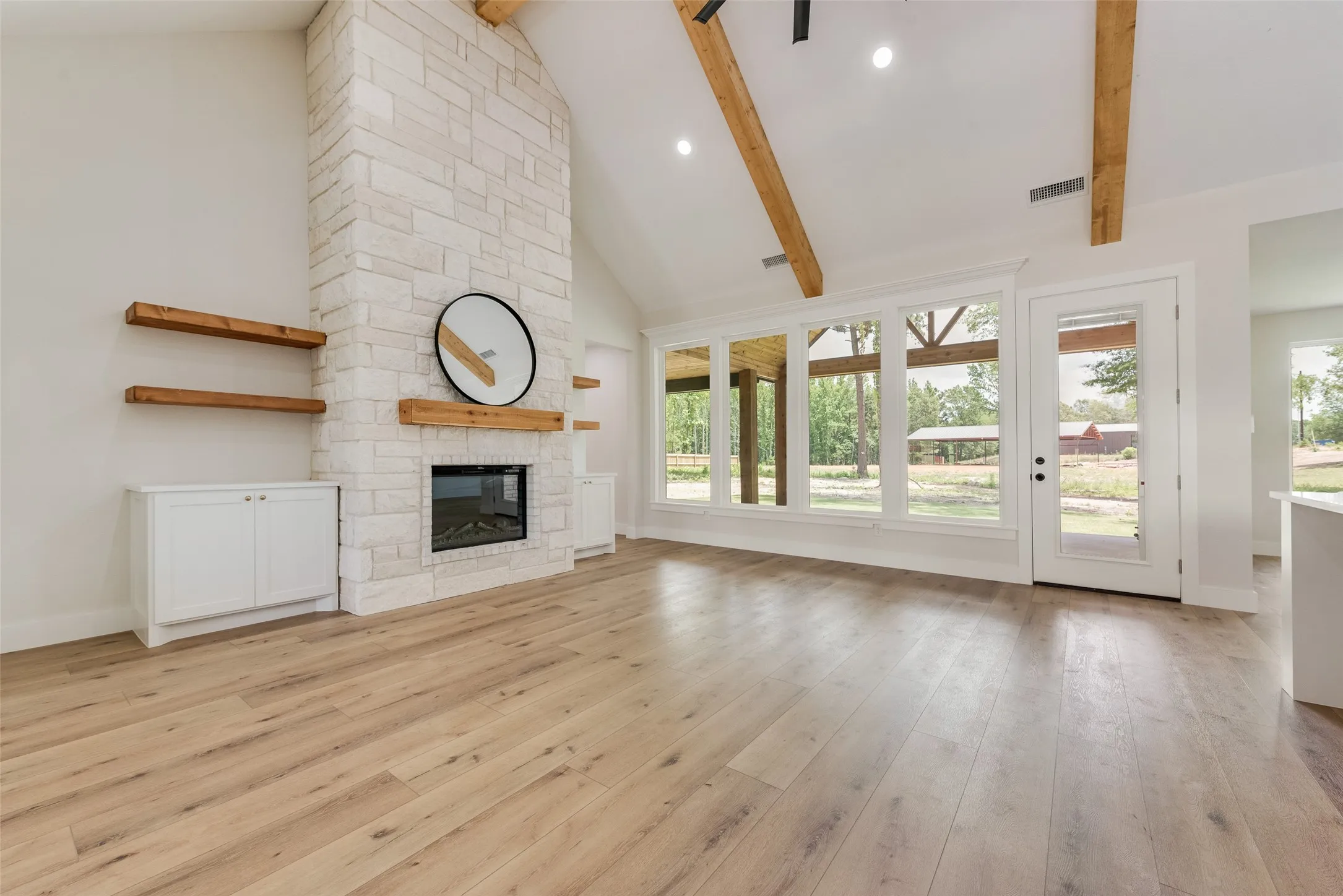 Vaulted ceiling featuring exposed wood beams and recessed lighting
