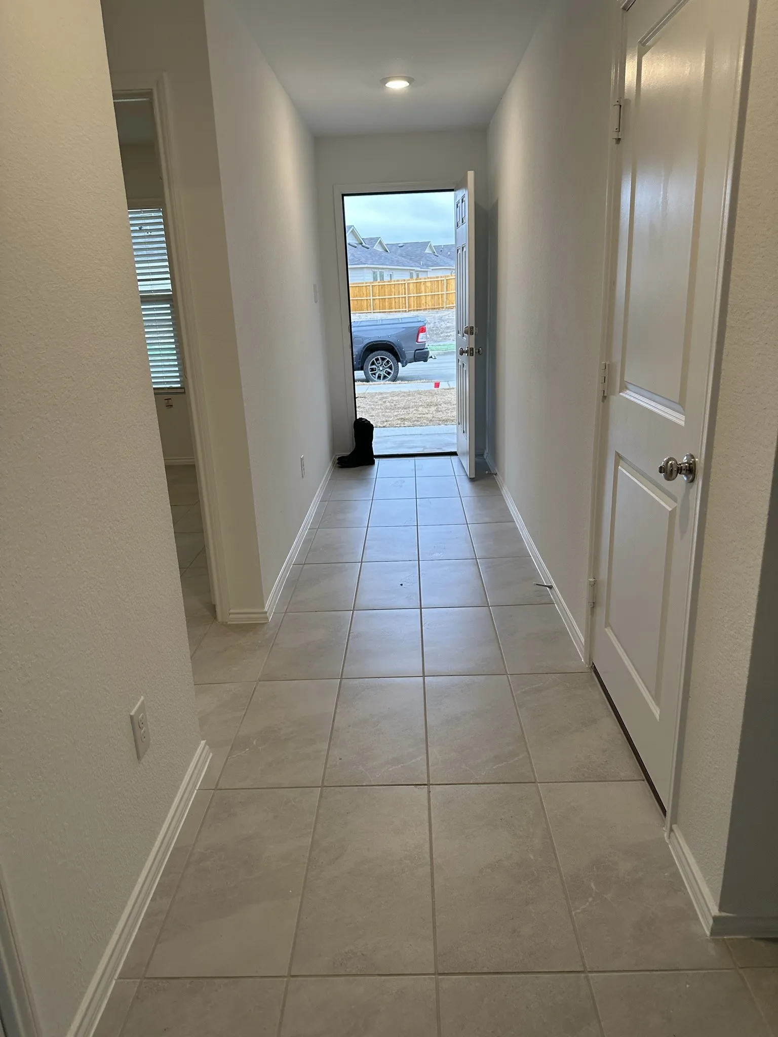 Hall featuring light tile patterned floors