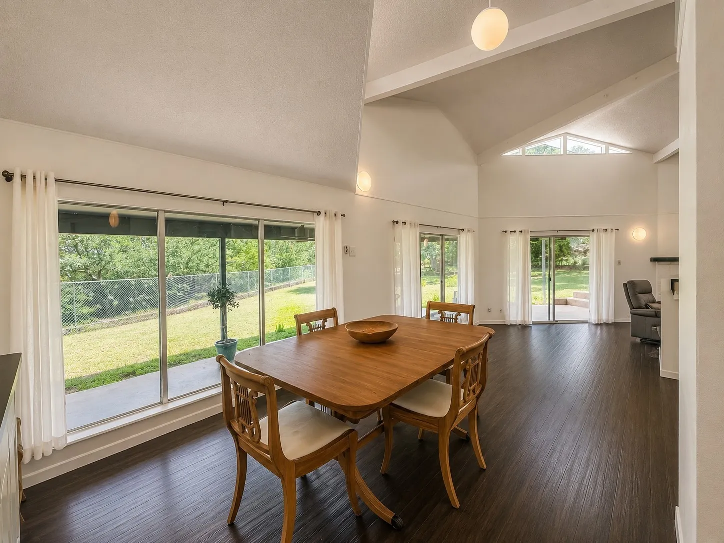Vaulted ceilings with exposed beams and an upper triangular window