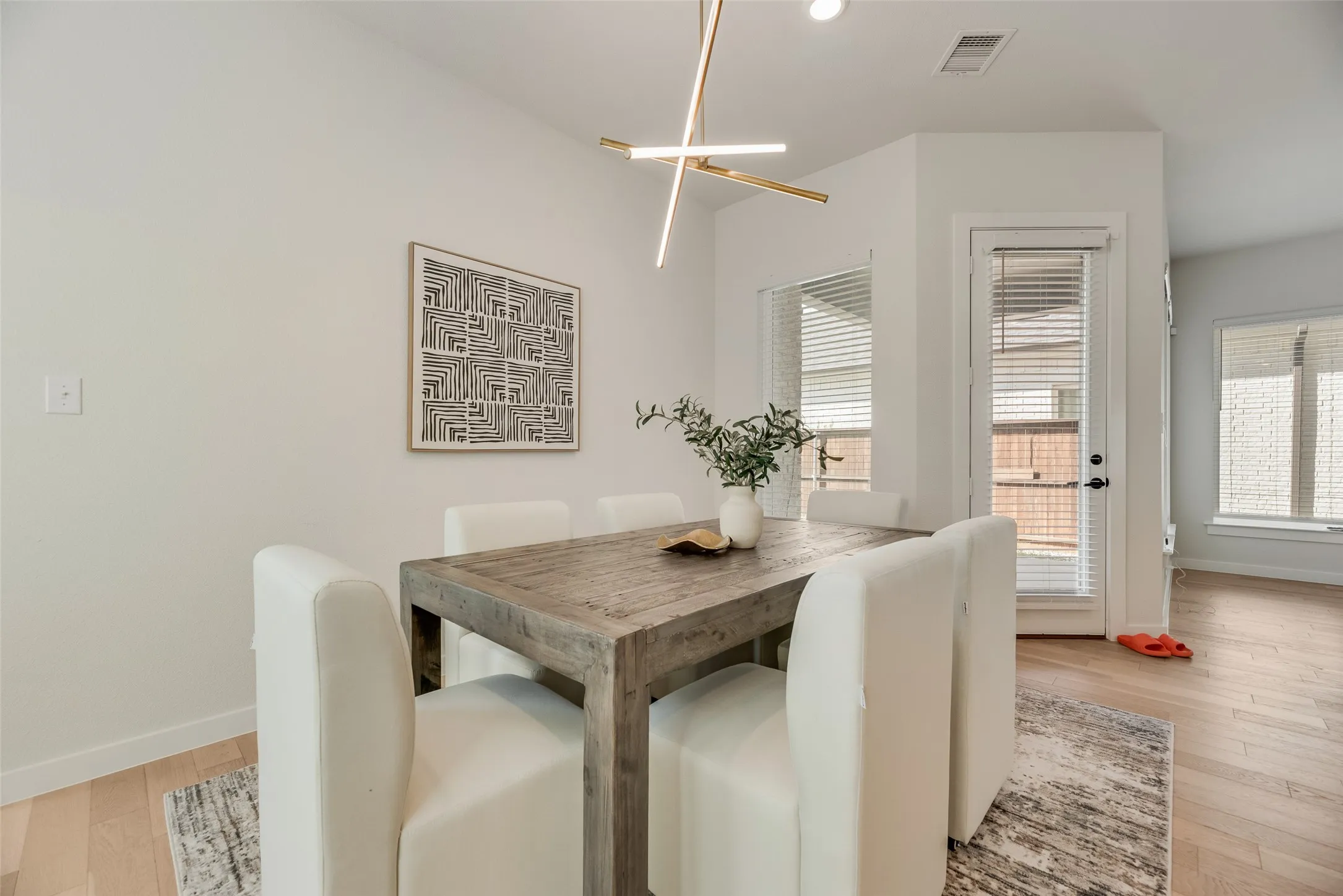 Open-concept living area with light wood-finish flooring
