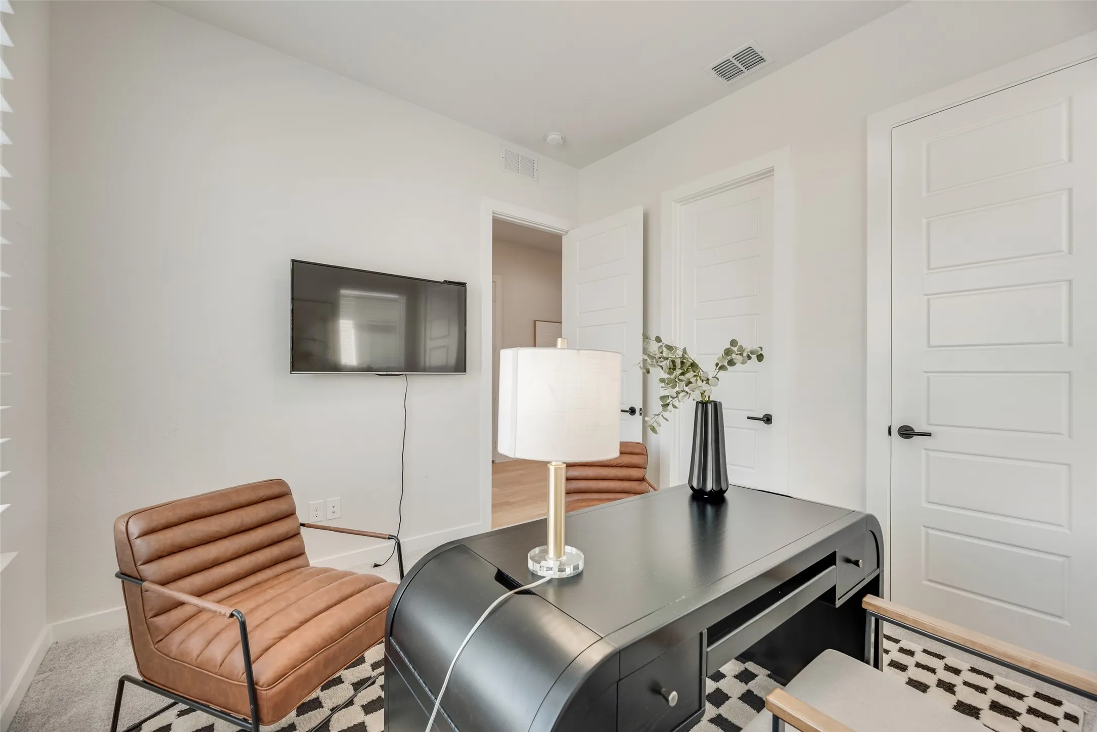 Interior room with white walls, recessed lighting, and a grey carpeted floor