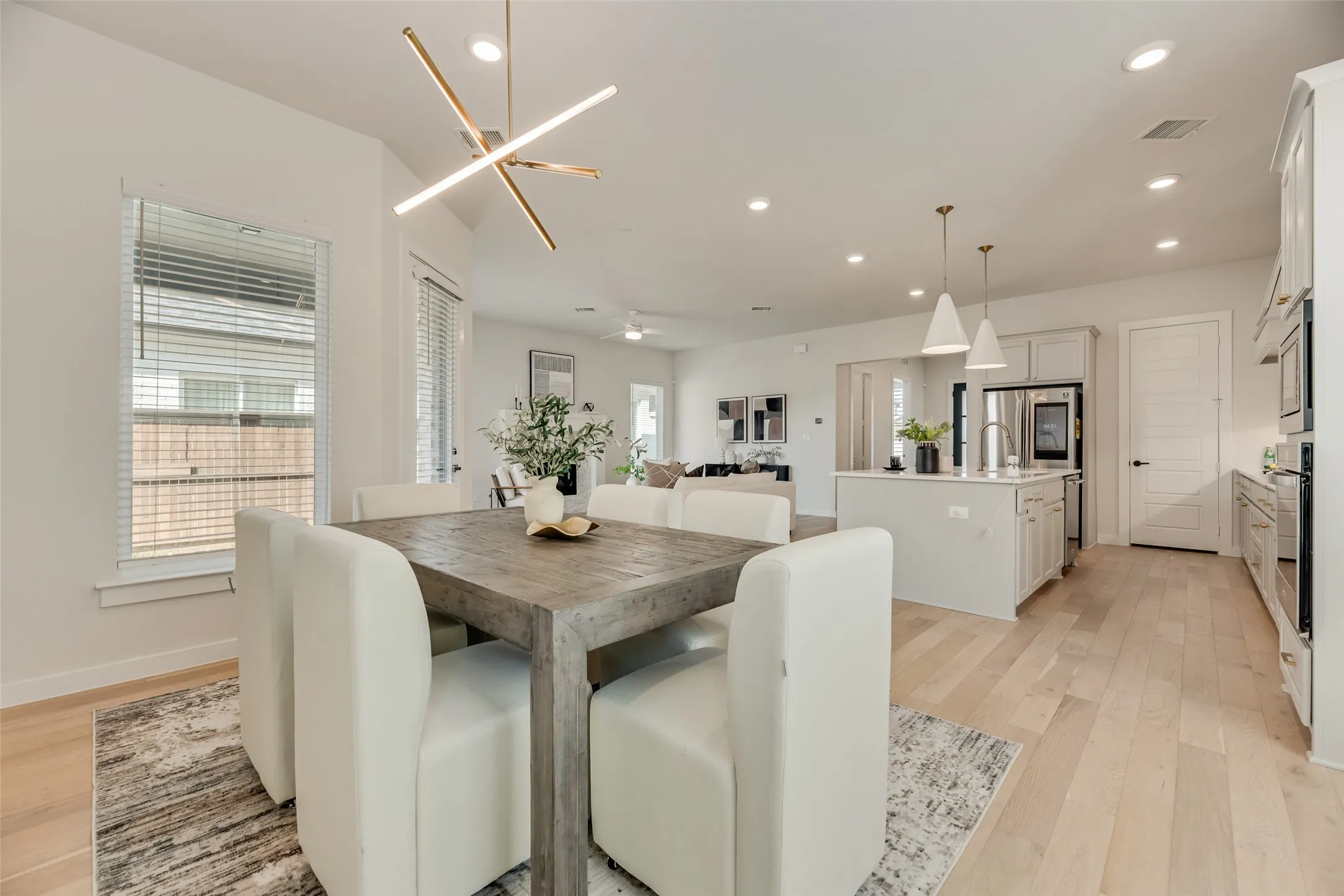 Open-concept interior featuring light wood-finish flooring throughout