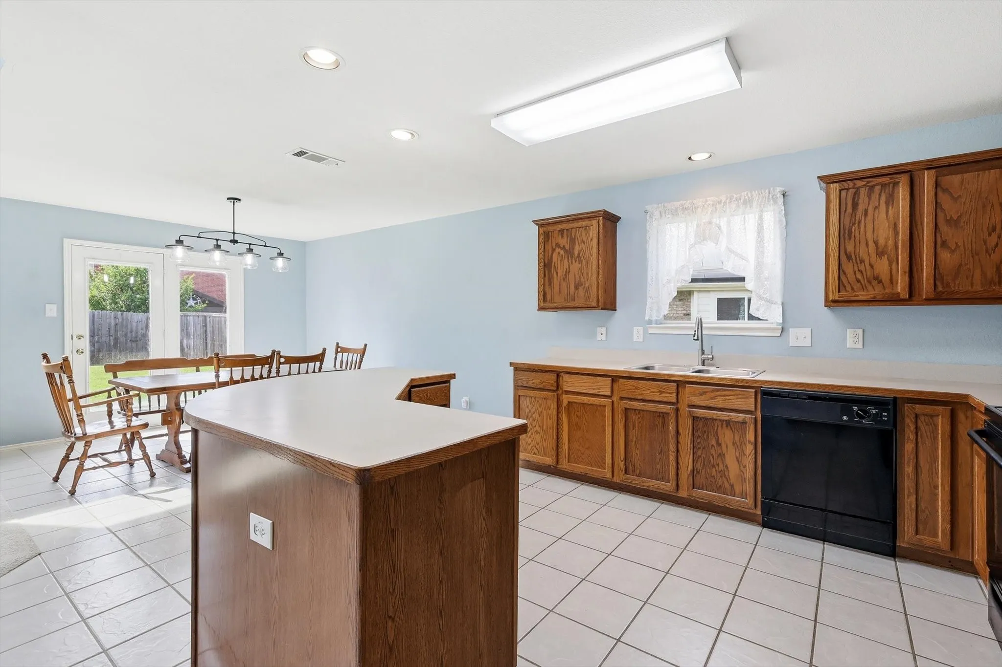 Open-concept kitchen featuring a breakfast bar and dining area