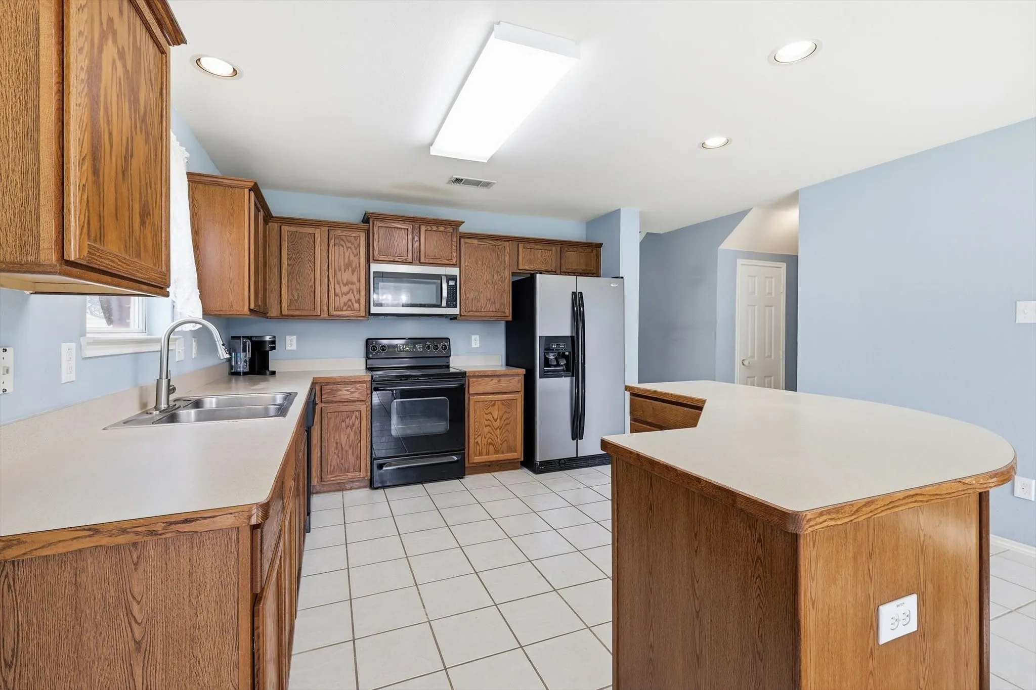 Open-concept kitchen featuring a breakfast bar and dining area